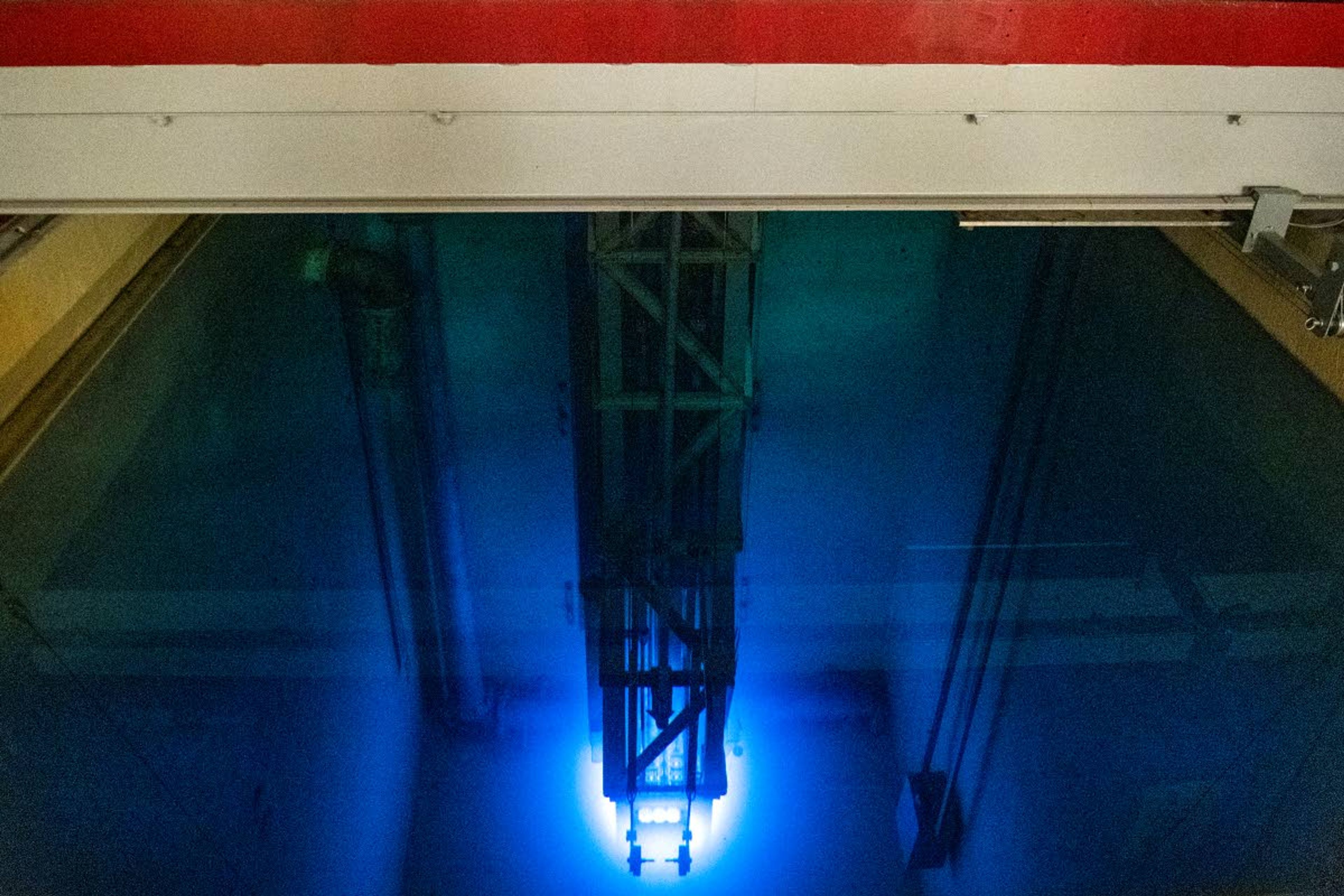 The core of a nuclear reactor glows blue as it’s immersed in a 25-foot-deep pool of water in the Nuclear Science Center at Washington State University.