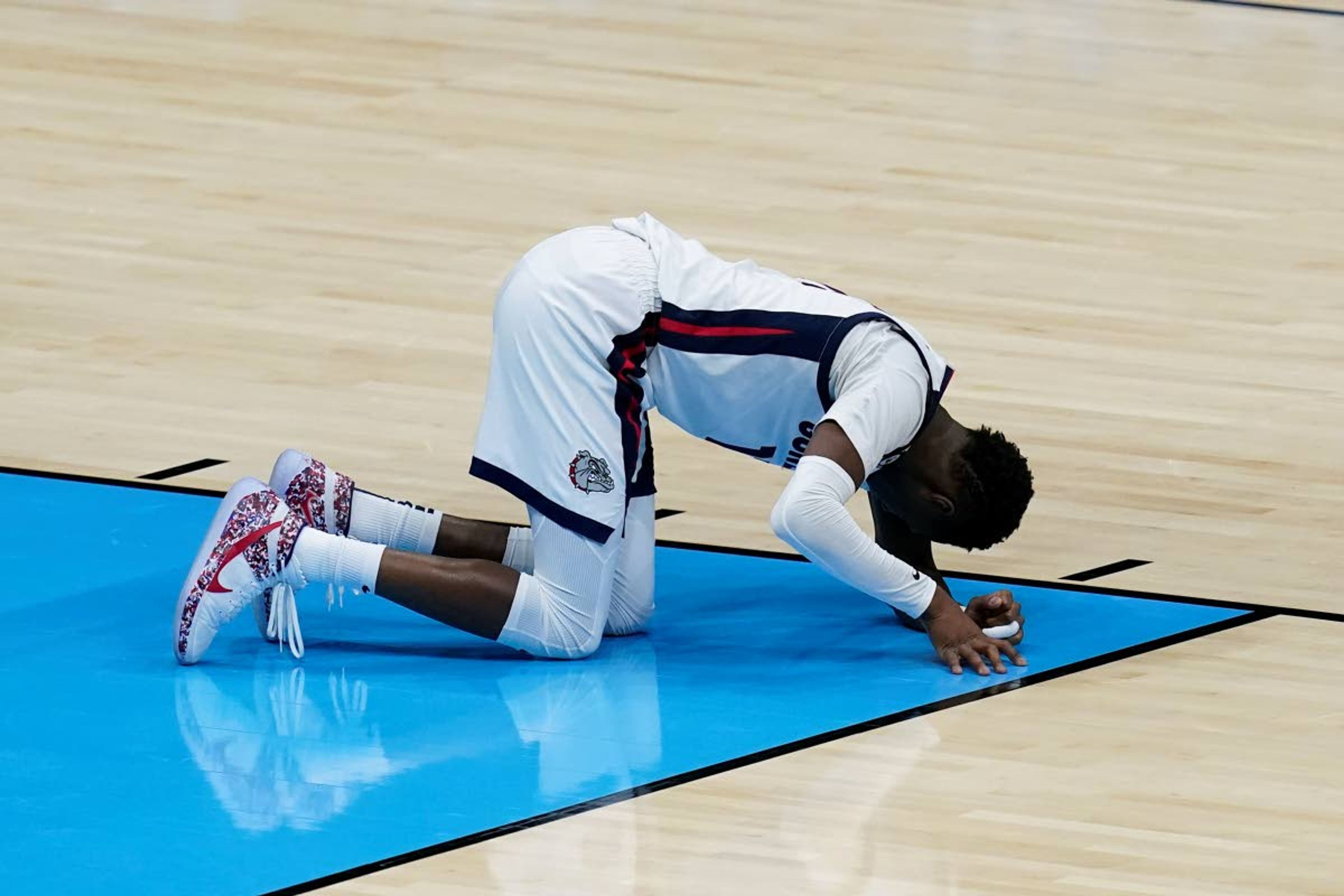 Gonzaga guard Joel Ayayi rests on the court after getting injured during the second half of the championship game against Baylor in the men's Final Four NCAA college basketball tournament, Monday, April 5, 2021, at Lucas Oil Stadium in Indianapolis. (AP Photo/Darron Cummings)