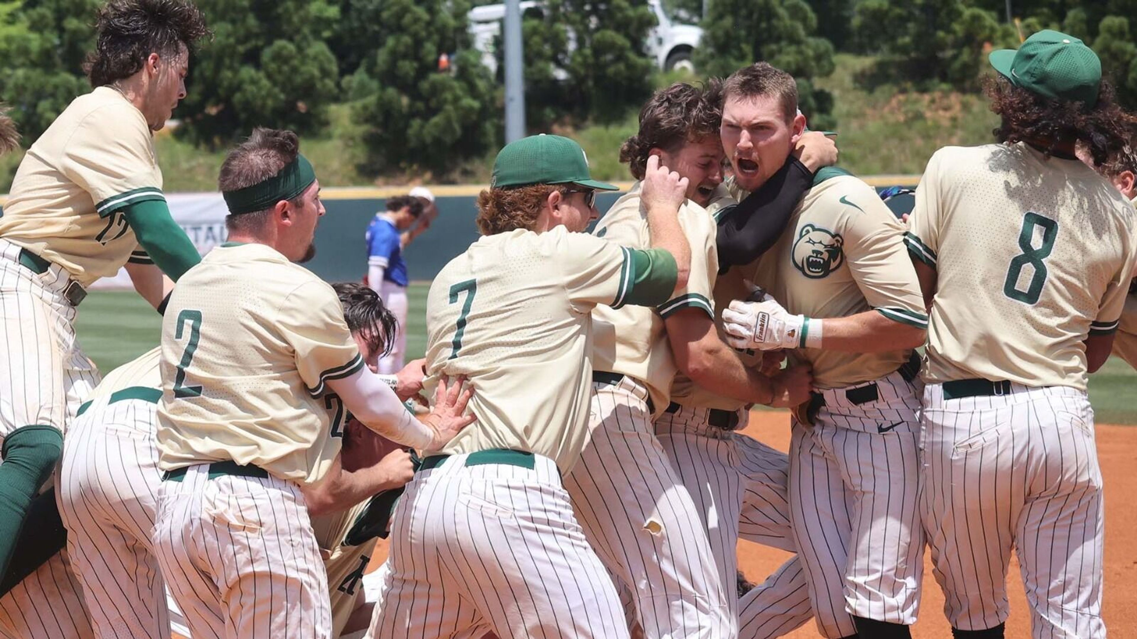 Paul Winland Jr., second from left, is mobbed by teammates after hitting ...