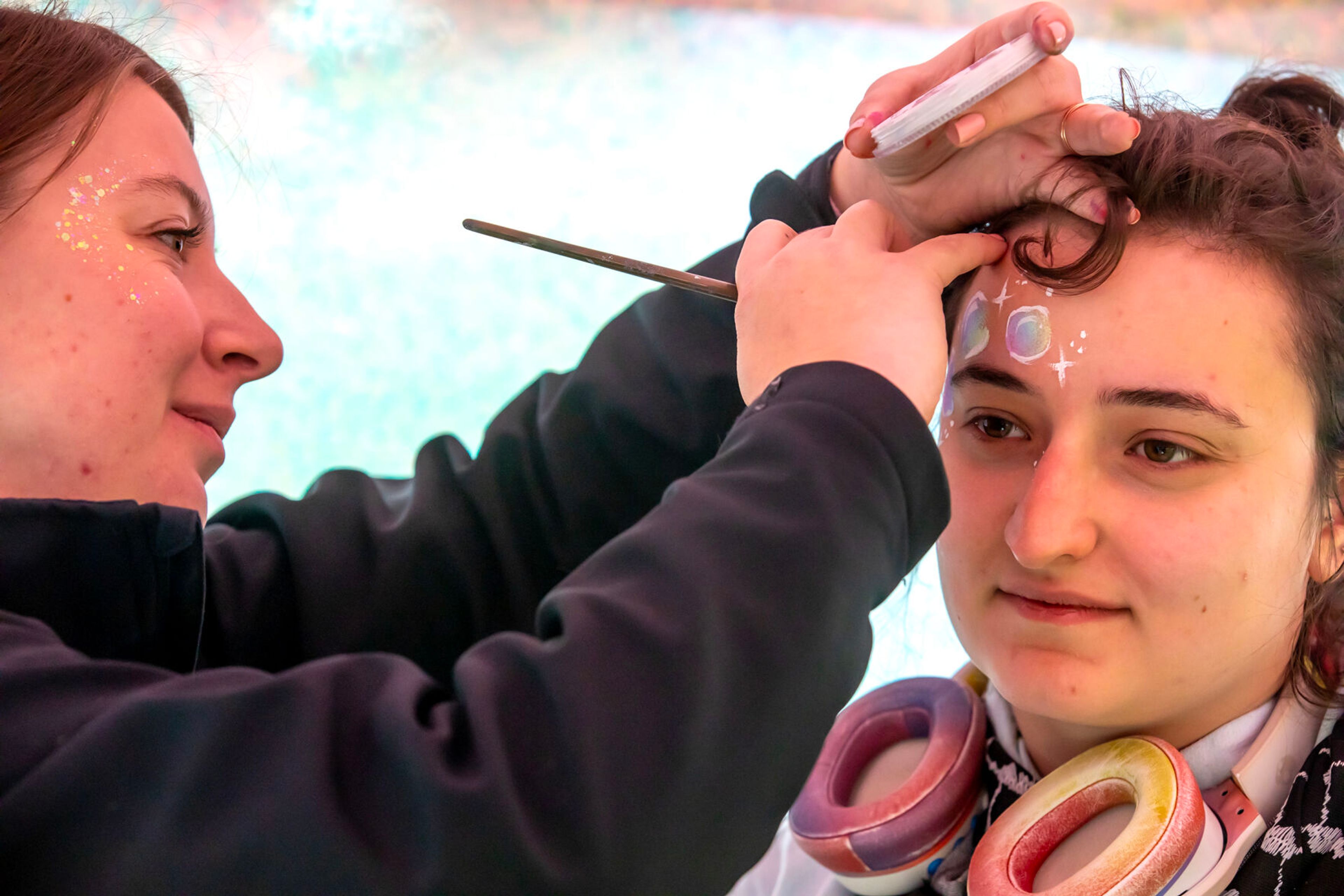 Shaelyn Jenkins paints the face of Anna Jones, of Moscow, at the Moscow Renaissance Fair Saturday at East City Park in Moscow.