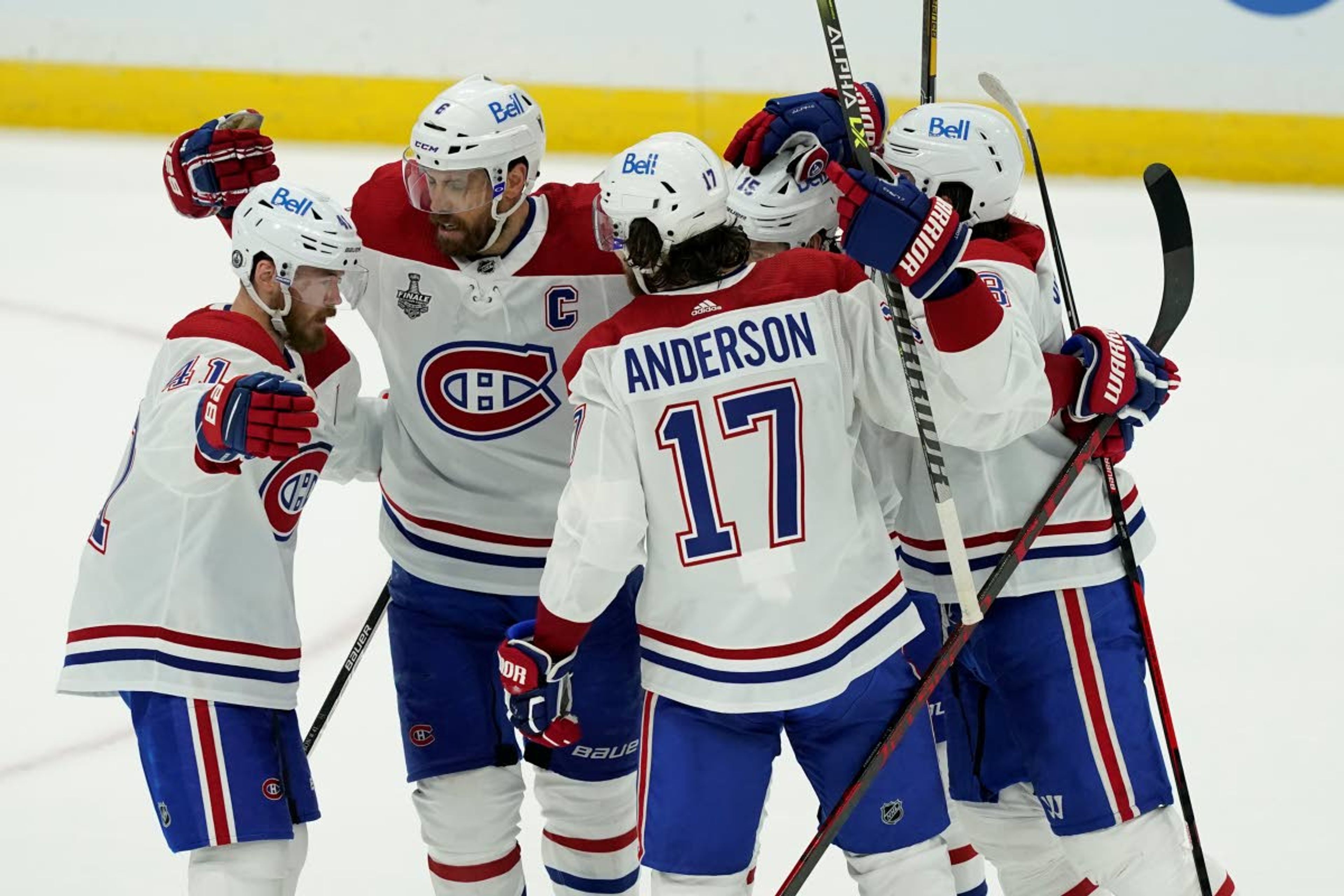 From left right wing Paul Byron, defenseman Shea Weber, right wing Josh Anderson, center Jesperi Kotkaniemi and defenseman Ben Chiarot hug after Chiarot's goal during the second period in Game 1 of the NHL hockey Stanley Cup finals against the Tampa Bay Lightning, Monday, June 28, 2021, in Tampa, Fla. (AP Photo/Gerry Broome)