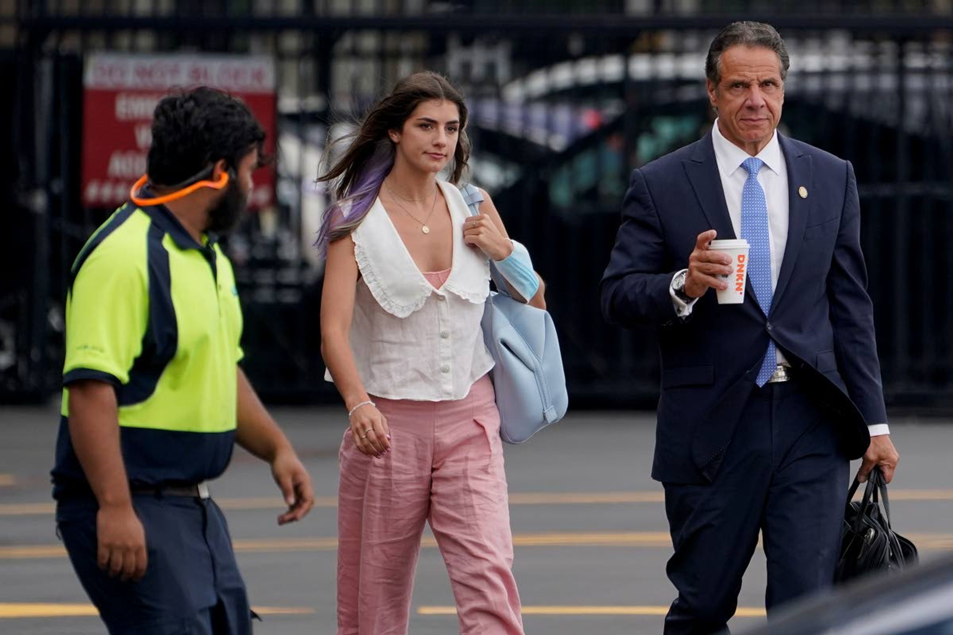 New York Gov. Andrew Cuomo, right, prepares to board a helicopter with his daughter Michaela Cuomo after announcing his resignation, Tuesday, Aug. 10, 2021, in New York. Cuomo says he will resign over a barrage of sexual harassment allegations. The three-term Democratic governor's decision, which will take effect in two weeks, was announced Tuesday as momentum built in the Legislature to remove him by impeachment. (AP Photo/Seth Wenig)