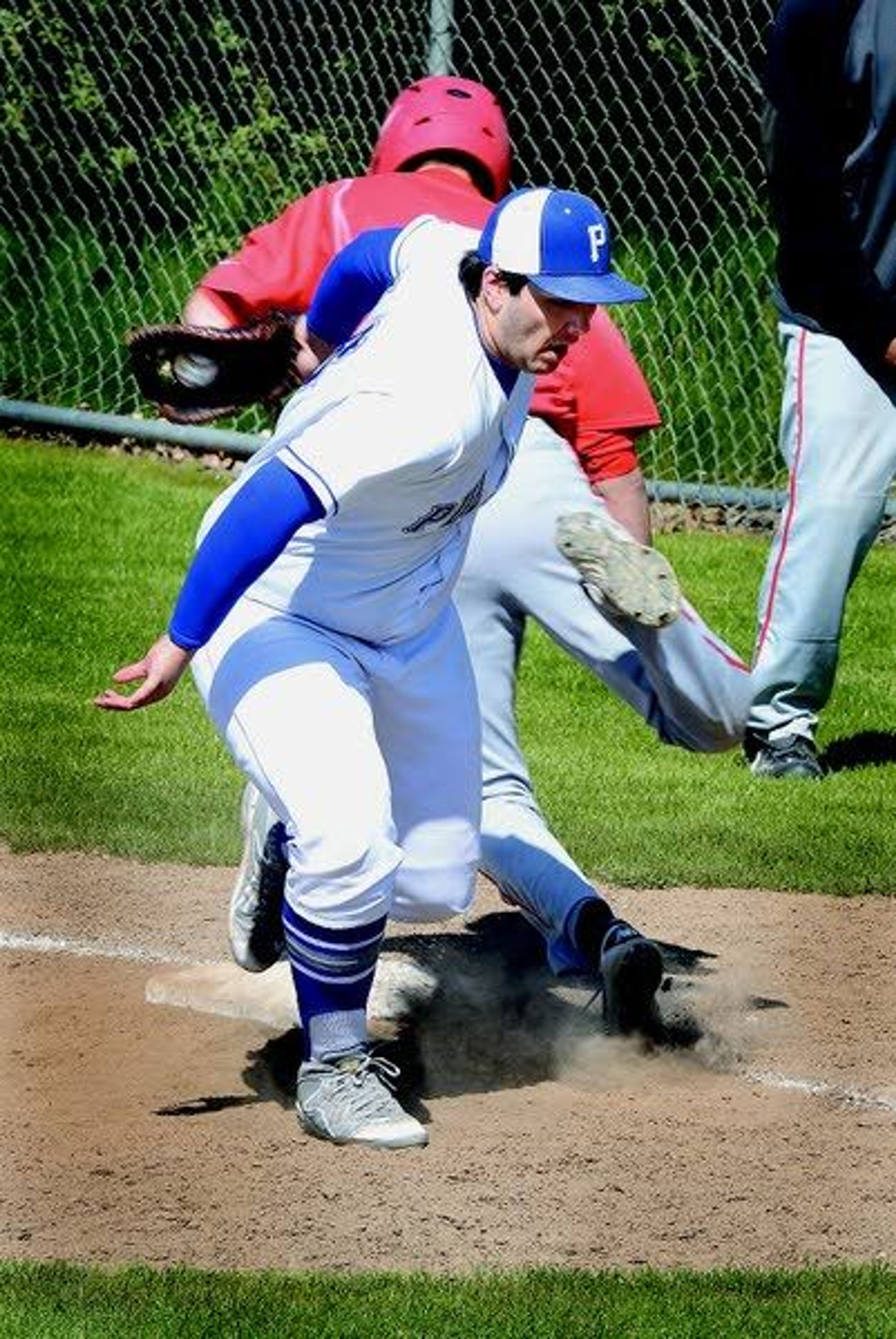 Pullman’s Evan Parks, front, collides with Clarkston’s Josh Lane as he tags him out in the top of the fifith inning Wednesday at Quann Field in Pullman.