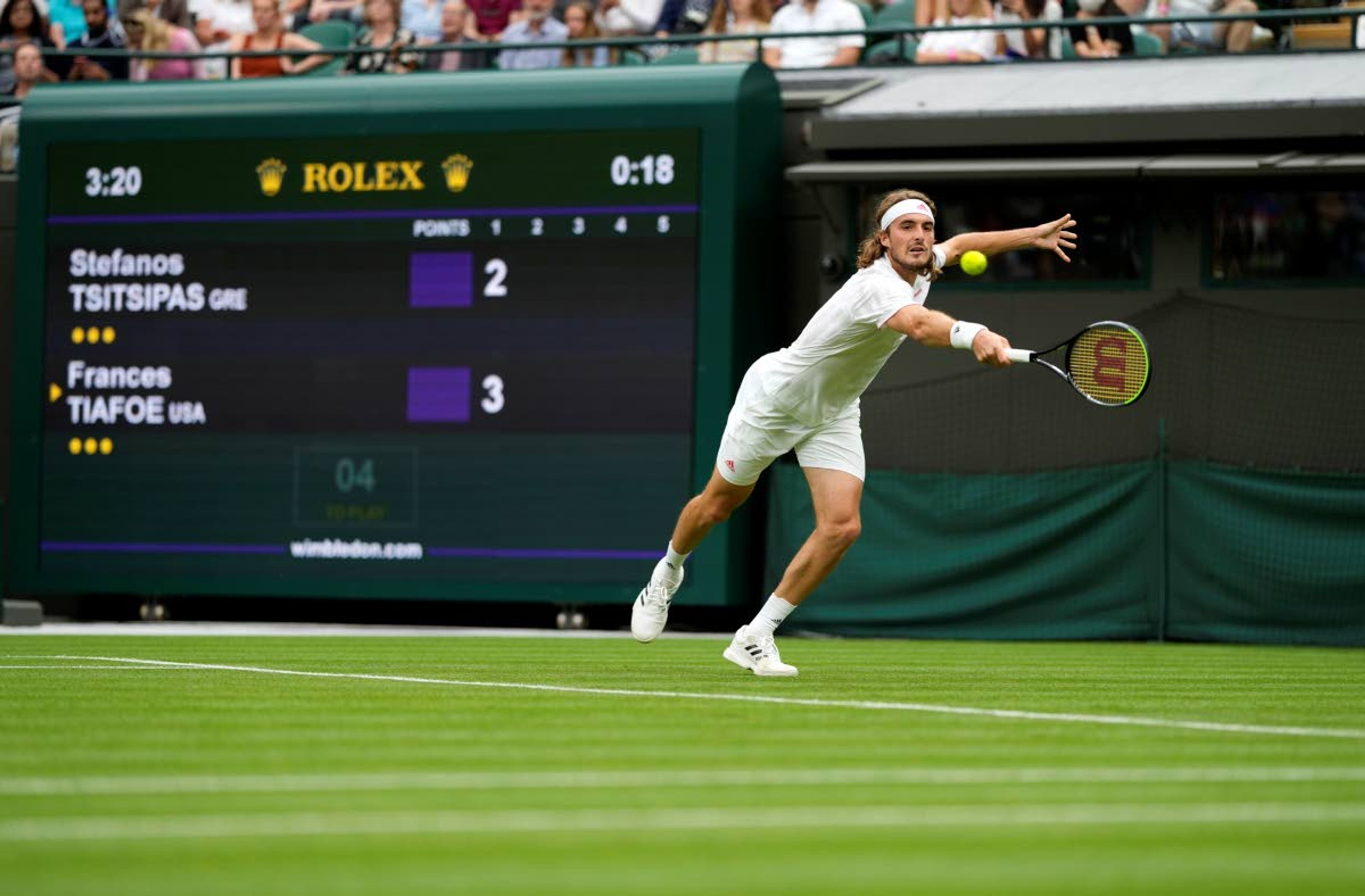 Stefanos Tsitsipas of Greece returns the ball to Frances Tiafoe of the US during the men's singles match on day one of the Wimbledon Tennis Championships in London, Monday June 28, 2021. (AP Photo/Alastair Grant)