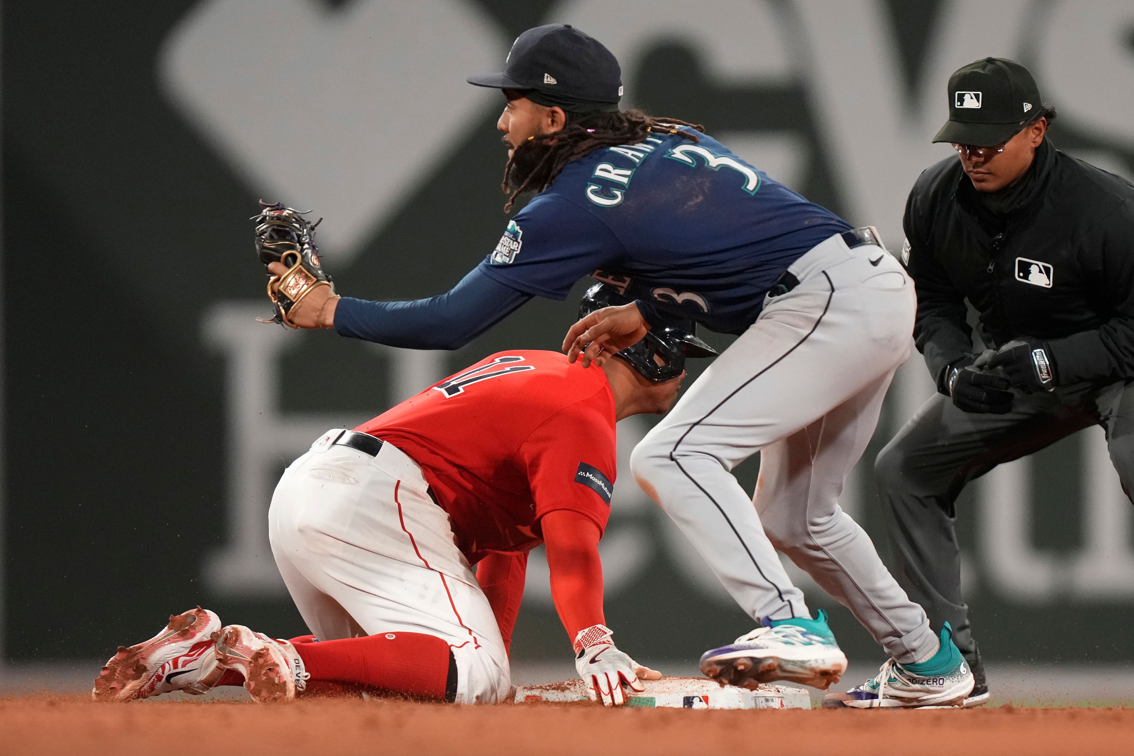 Boston Red Sox's Rafael Devers (11) is safe at second with a double as Seattle Mariners' J.P. Crawford (3) catches the throw the fifth inning of a baseball game Wednesday, May 17, 2023, in Boston. (AP Photo/Steven Senne)