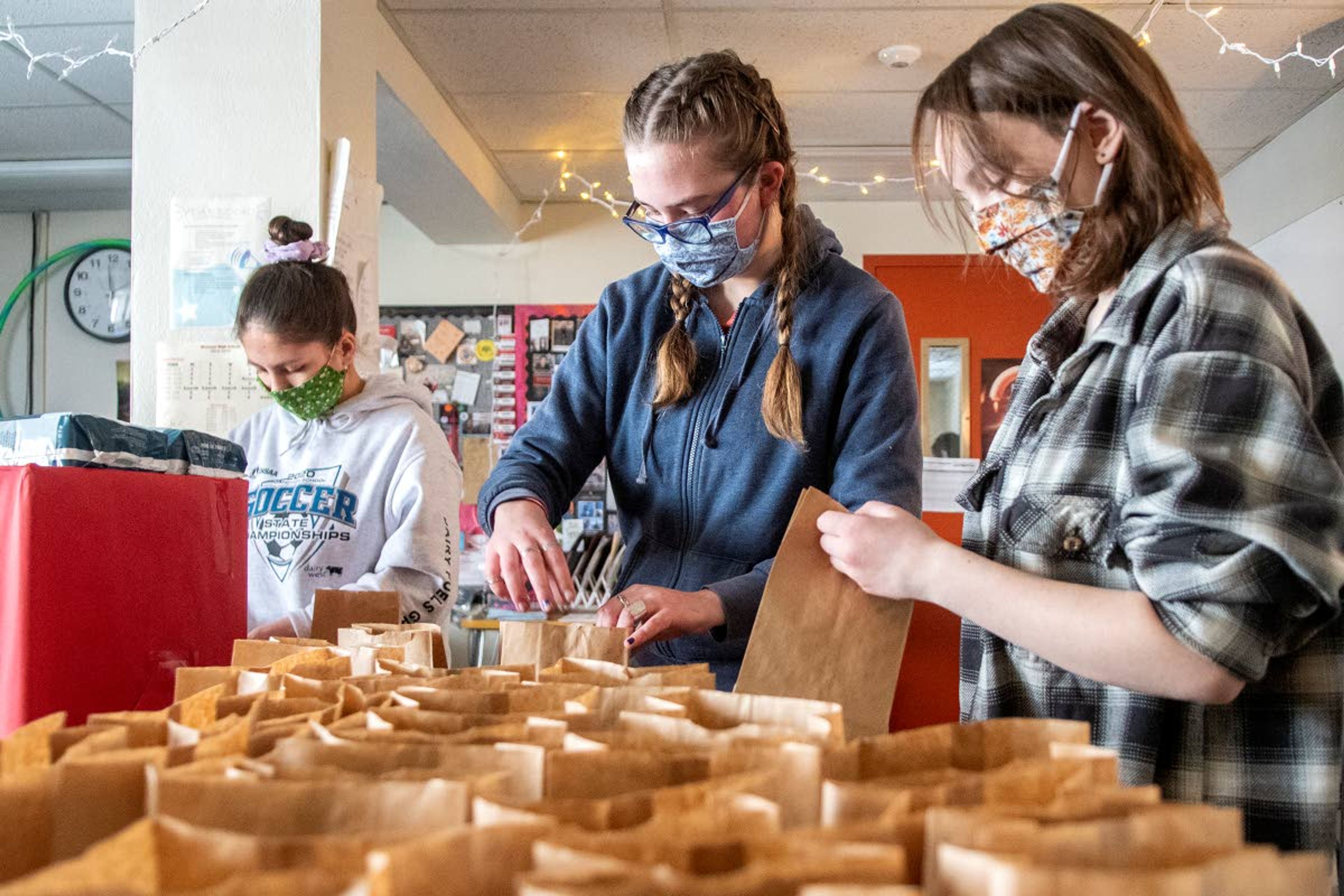 Members of “PERIOD: The Menstrual Movement,” sophomore Grace Clevenger, from left to right, juniors Molly Klingler and Jamie Erhard-Hudson, package period product supplies at Moscow High School on Wednesday afternoon that will be donated to Family Promise of the Palouse and Alternatives to Violence of the Palouse.