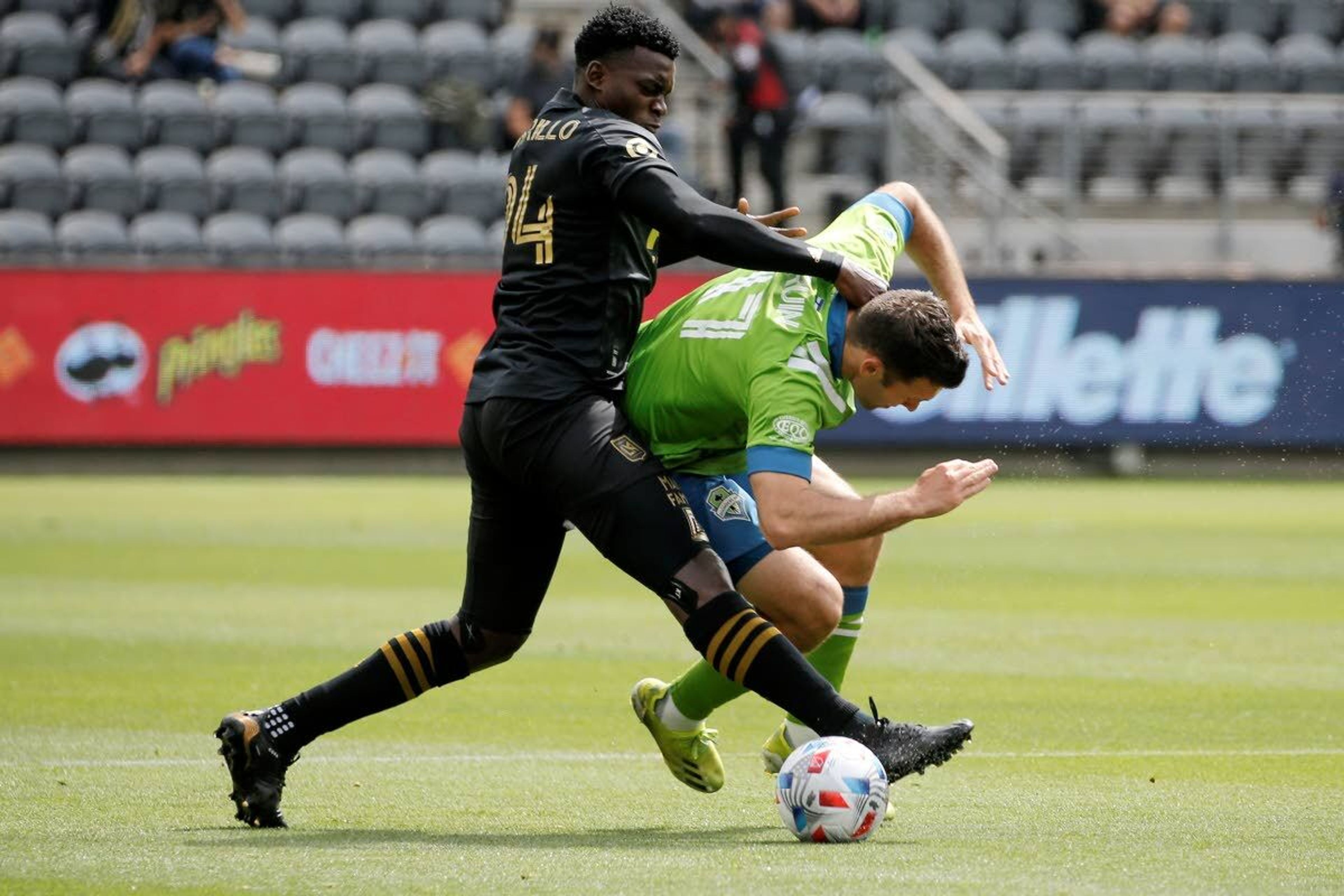 Los Angeles FC defender Jesus David Murillo (94) and Seattle Sounders forward Will Bruin (17) vie for the ball during the first half of an MLS soccer match, Saturday, April 24, 2021, in Los Angeles. (AP Photo/Ringo H.W. Chiu)