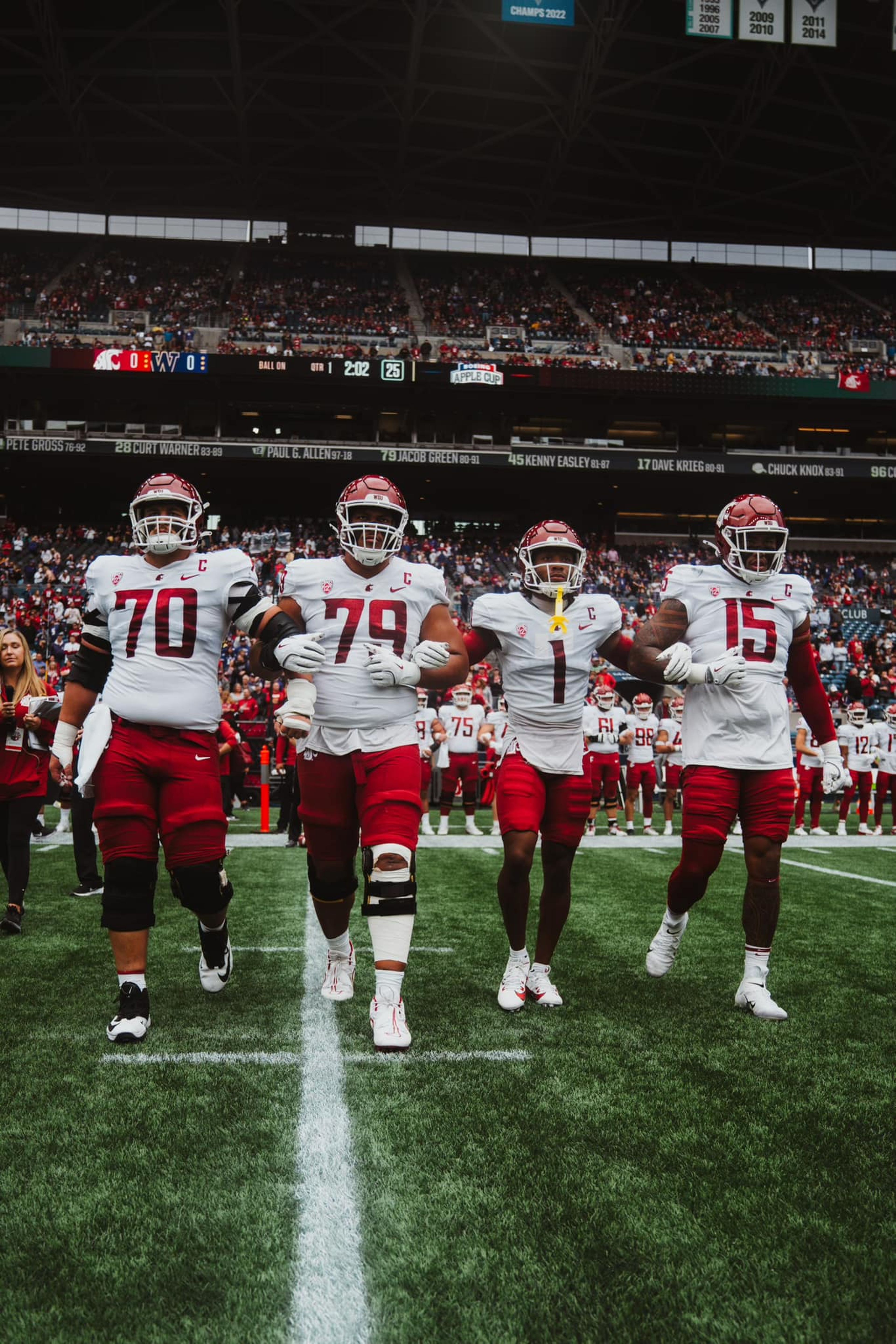 Washington State team captians Devin Kylany, Fa’alili Fa’amoe, Steve Hall and Nusi Malani walk to midfield prior to the Apple Cup, Sept. 14 2024, at Lumen Field in Seattle.