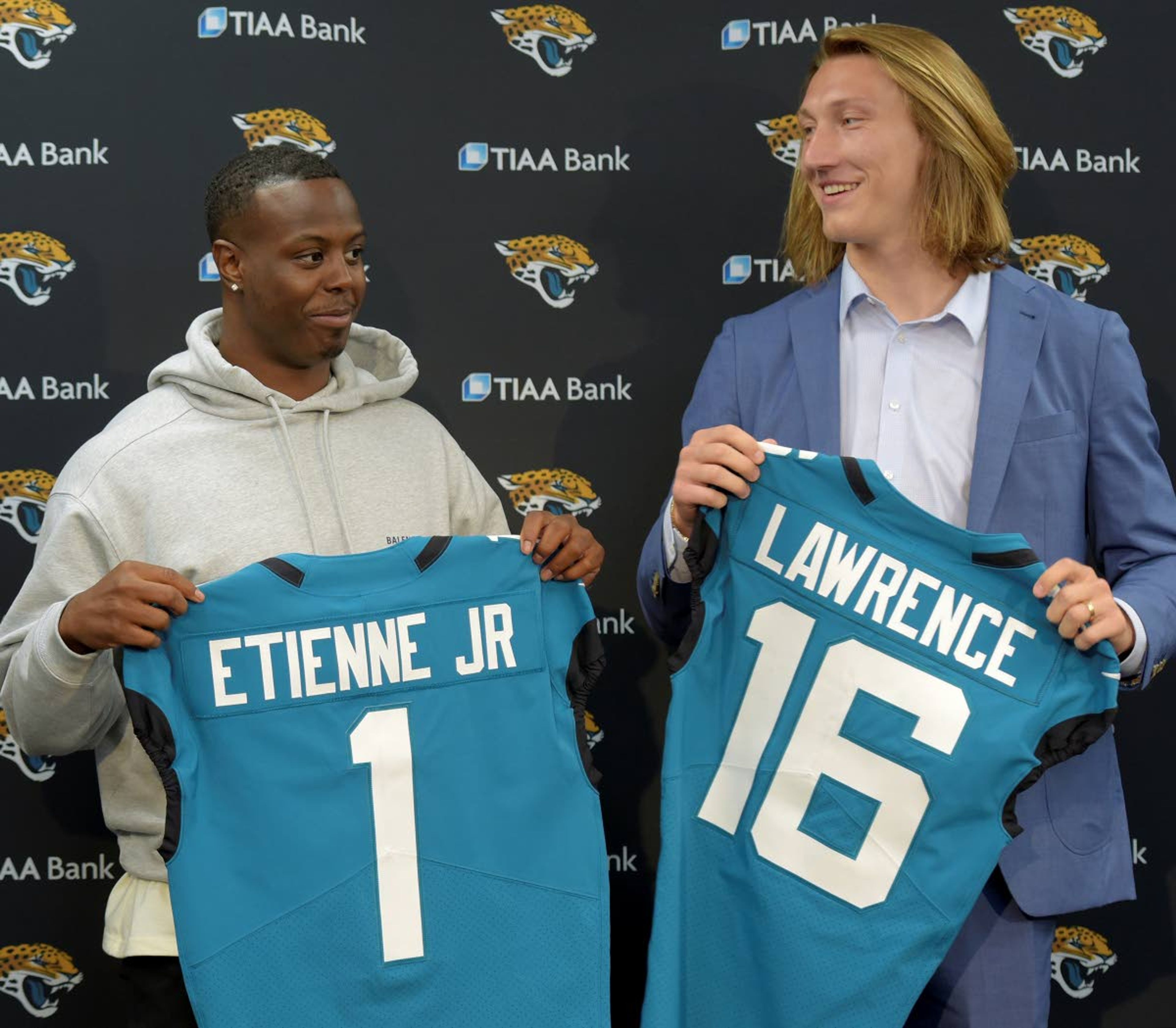 Former Clemson teammates Travis Etienne and Trevor Lawrence pose with their Jaguars jerseys during an introductory news conference in Jacksonville, Fla., in this April 30 photo.