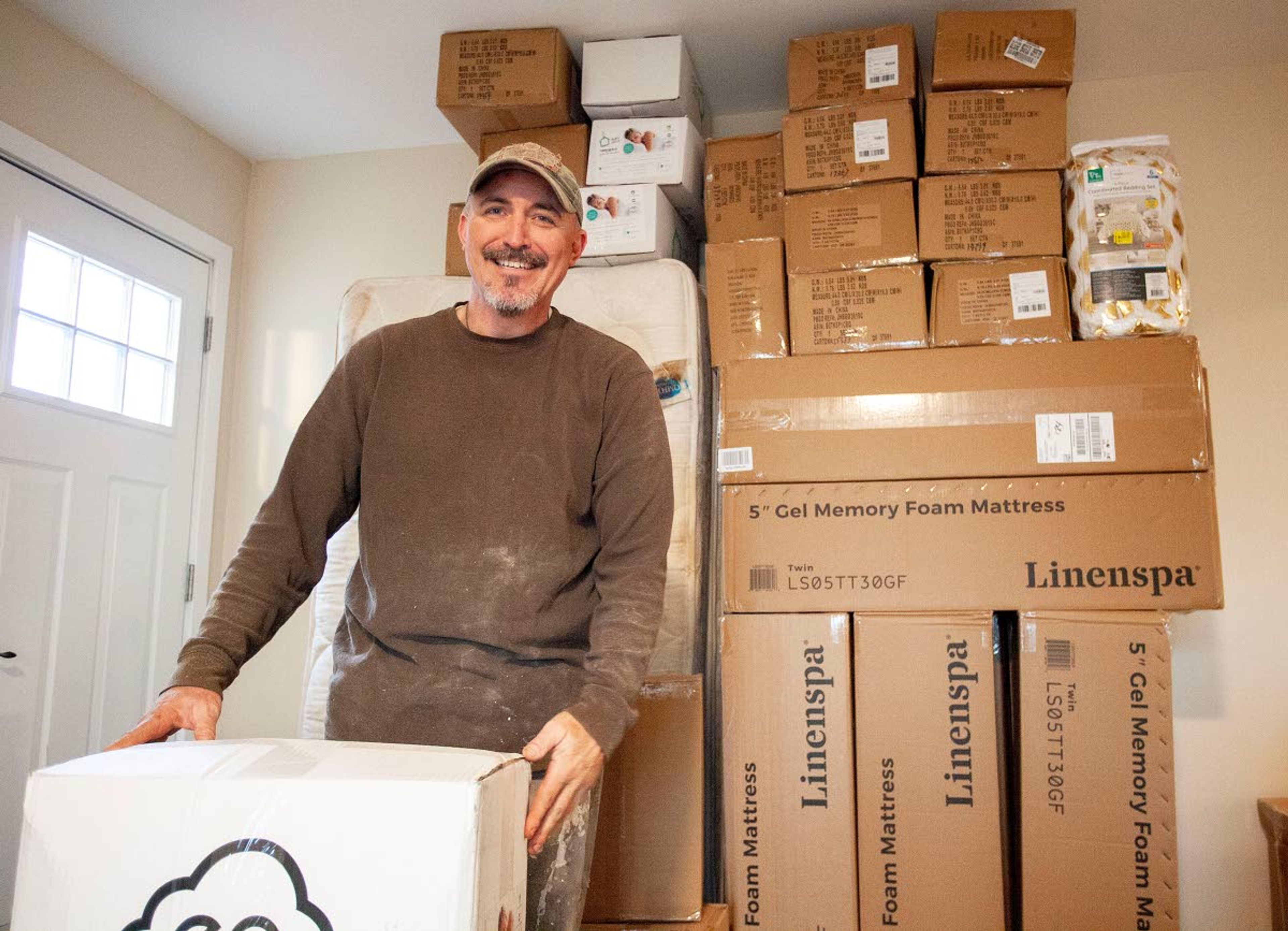 Blessing Beds founder Thad DeBuhr talks about some of the donated mattresses, bedding and pillows on Friday, Feb. 7, at his home in Pullman.