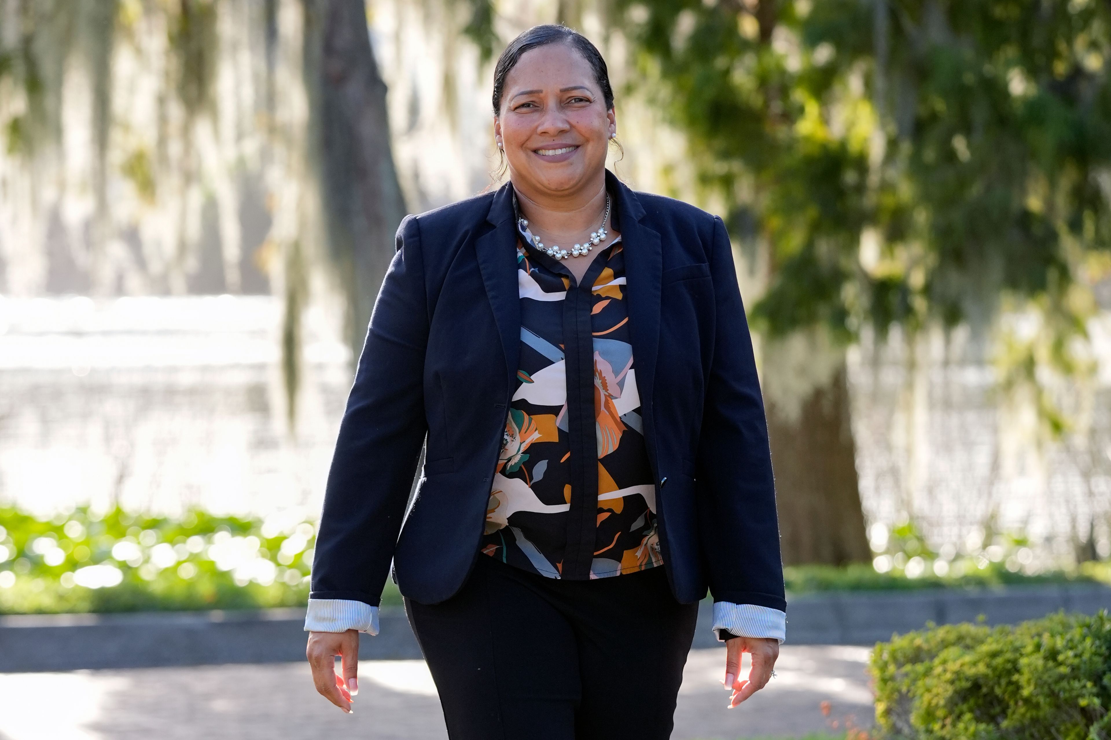 Marisol Ortega, a Polk County resident that commutes to her job in Orlando walks at a park Thursday, Nov. 14, 2024, in Orlando, Fla. (AP Photo/John Raoux)