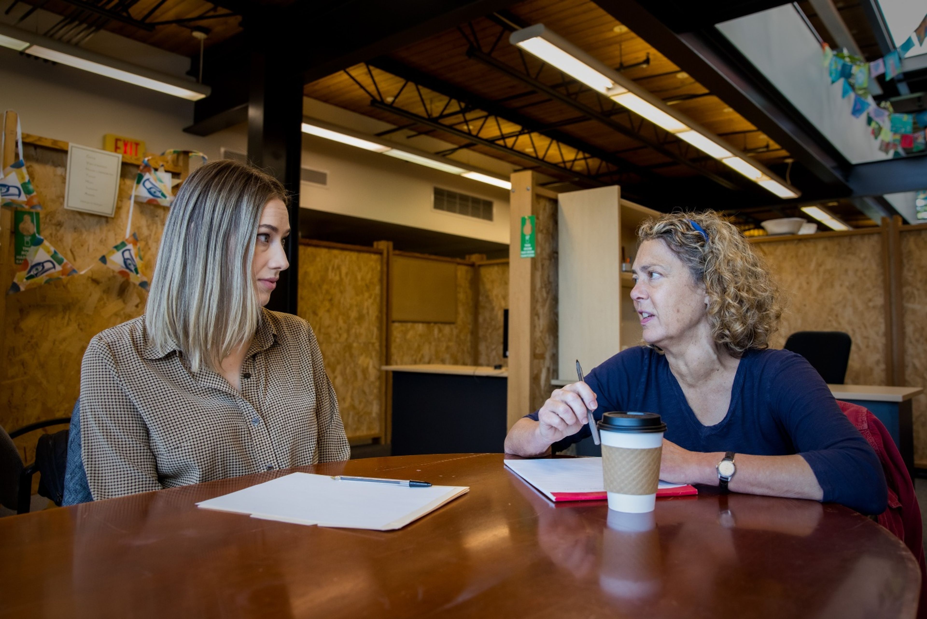 Stacey Marron, right, domestic violence program manager at Broadview Shelter and Transitional Housing, meets with Kelsey Fleetwood, a legal advocate, at Solid Ground’s main headquarters in Seattle.