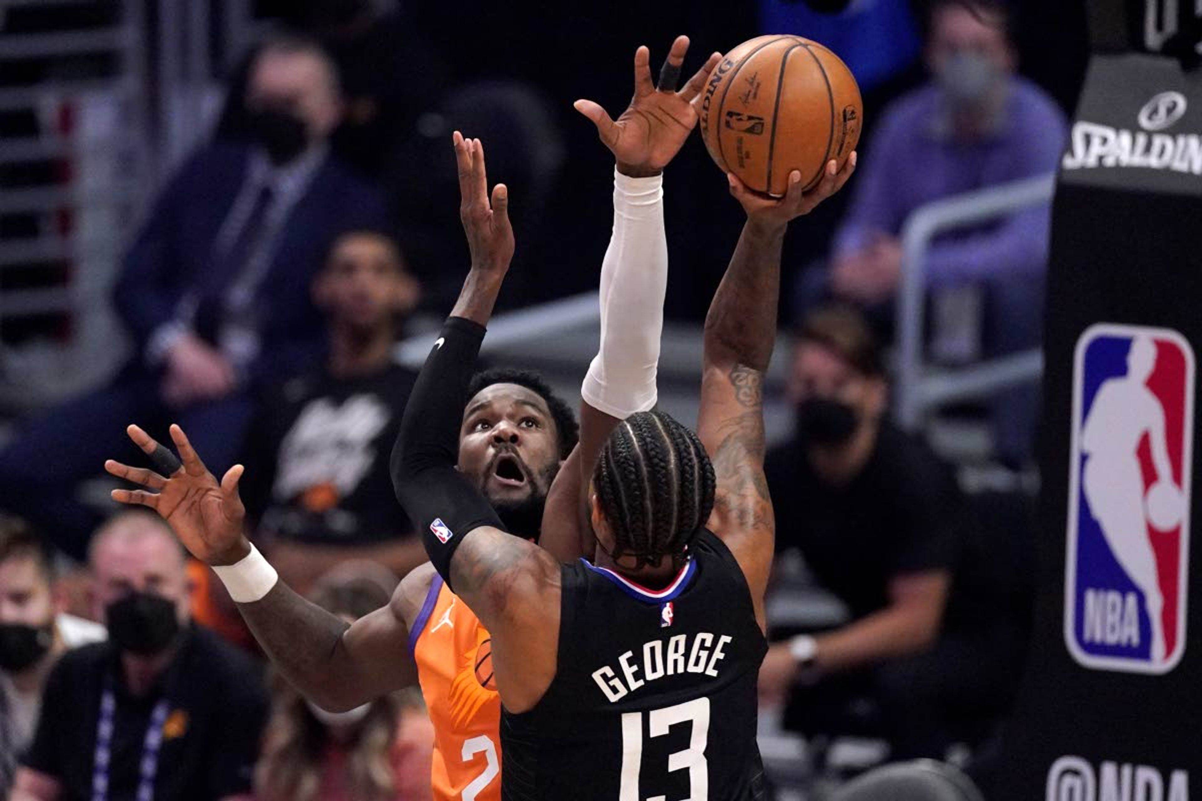 Los Angeles Clippers guard Paul George, right, shoots as Phoenix Suns center Deandre Ayton defends during the first half in Game 6 of the NBA basketball Western Conference Finals Wednesday, June 30, 2021, in Los Angeles. (AP Photo/Mark J. Terrill)