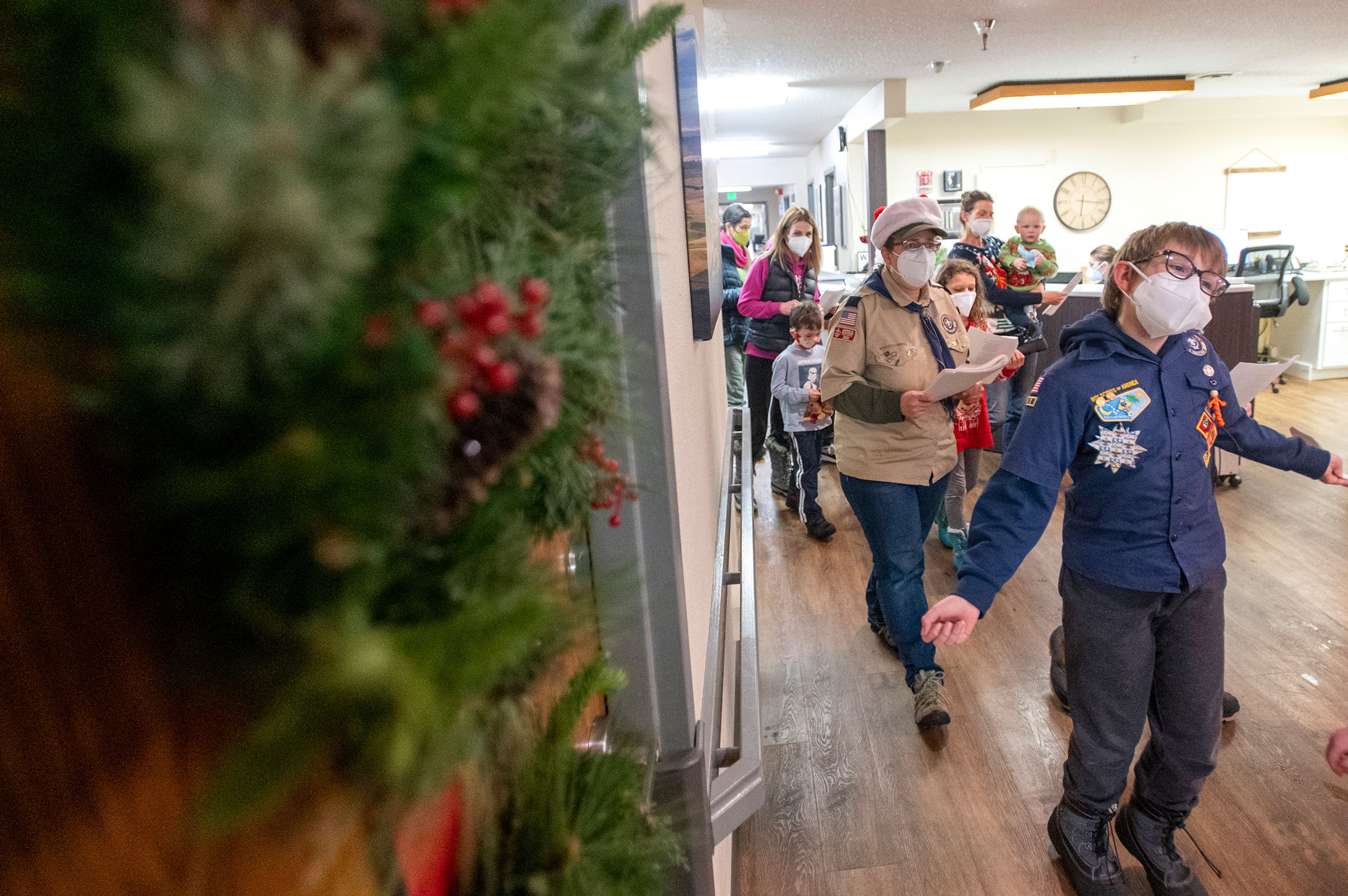 Scouts sing Christmas carols up and down the hallway at Aspen Park of Cascadia in Moscow.