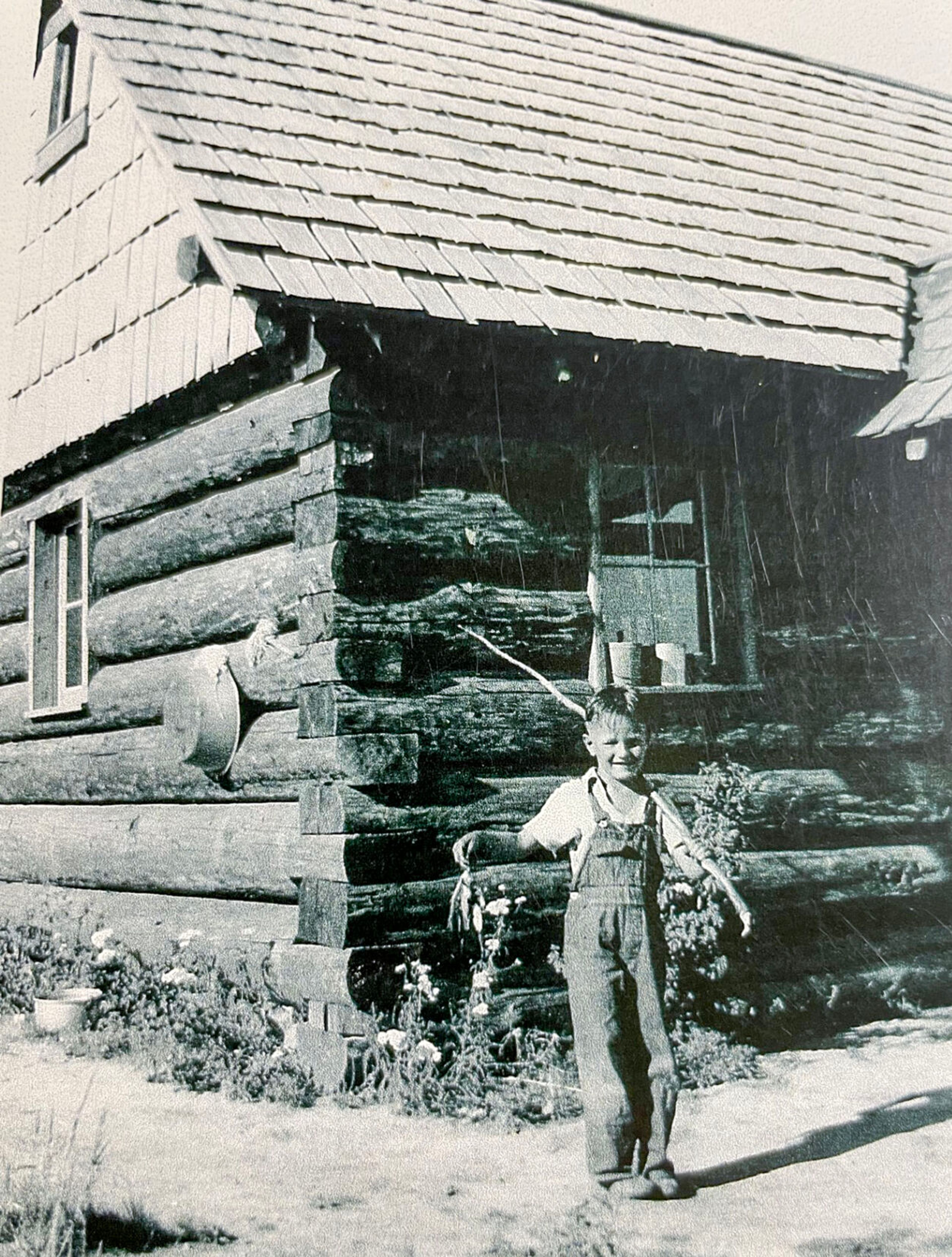 Stanley Stater poses in front of the cabin with his catch after fishing in Hatter Creek. (Andy Bull collection)