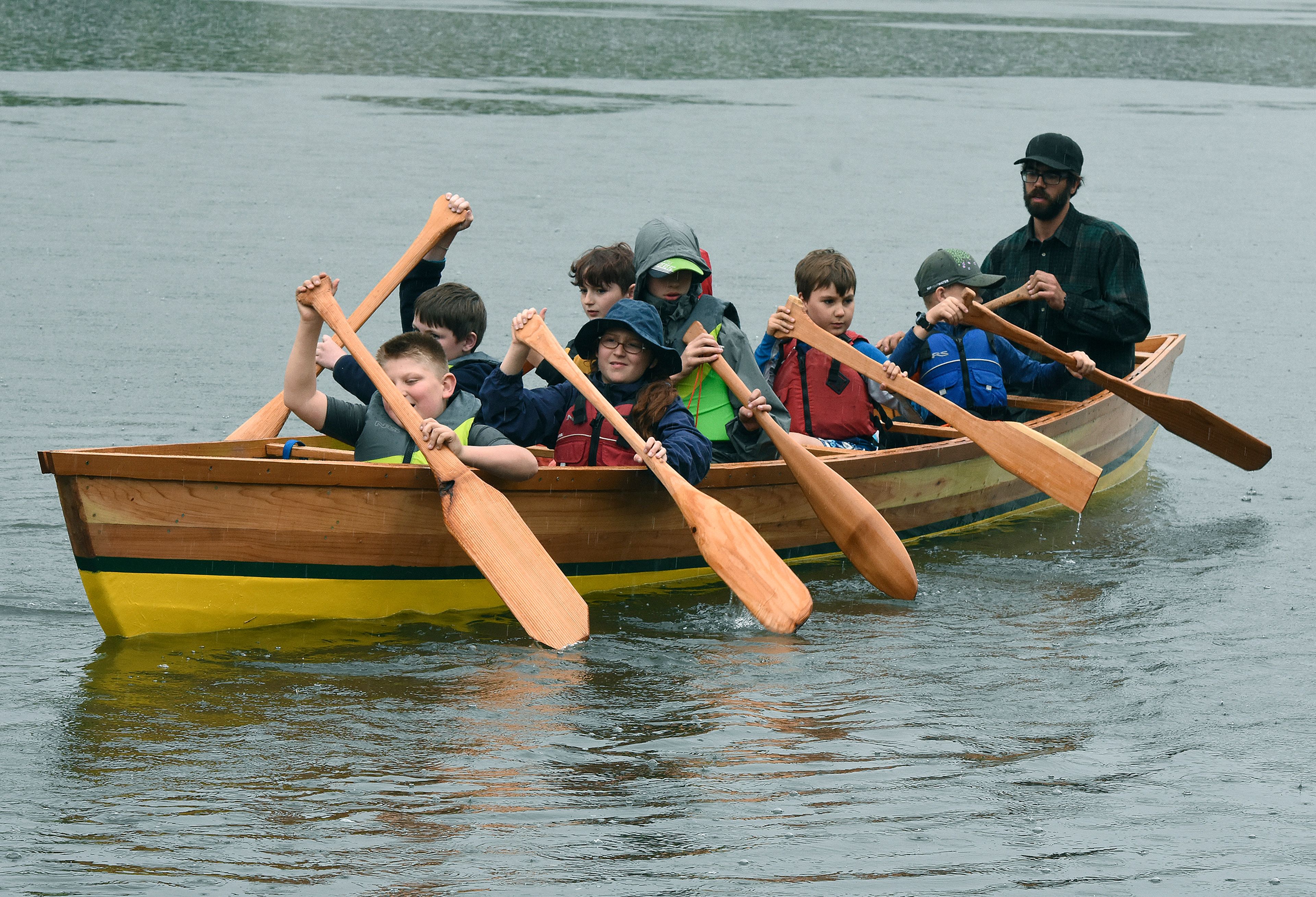 With guidance from Xander Demetrious and Adam Wicks-Arshack, Renee Hill’s fourth grade students built the 22 foot cedar plank canoe at Palouse Prairie Charter School at Moscow in their spare time over two months, while studying canoes and American Indian culture. With the help of Nez Perce Tribal members, the canoe, named The Chinook, was blessed Friday and then carried by all the students (“It’s heavy!”), and launched in the Snake River. The handmade boat was paddled around Silcott Island in a light rain. The canoe will be donated to the Nimiipuu Protecting The Environment group of the Nez Perce Tribe for teaching and regional demonstrations.