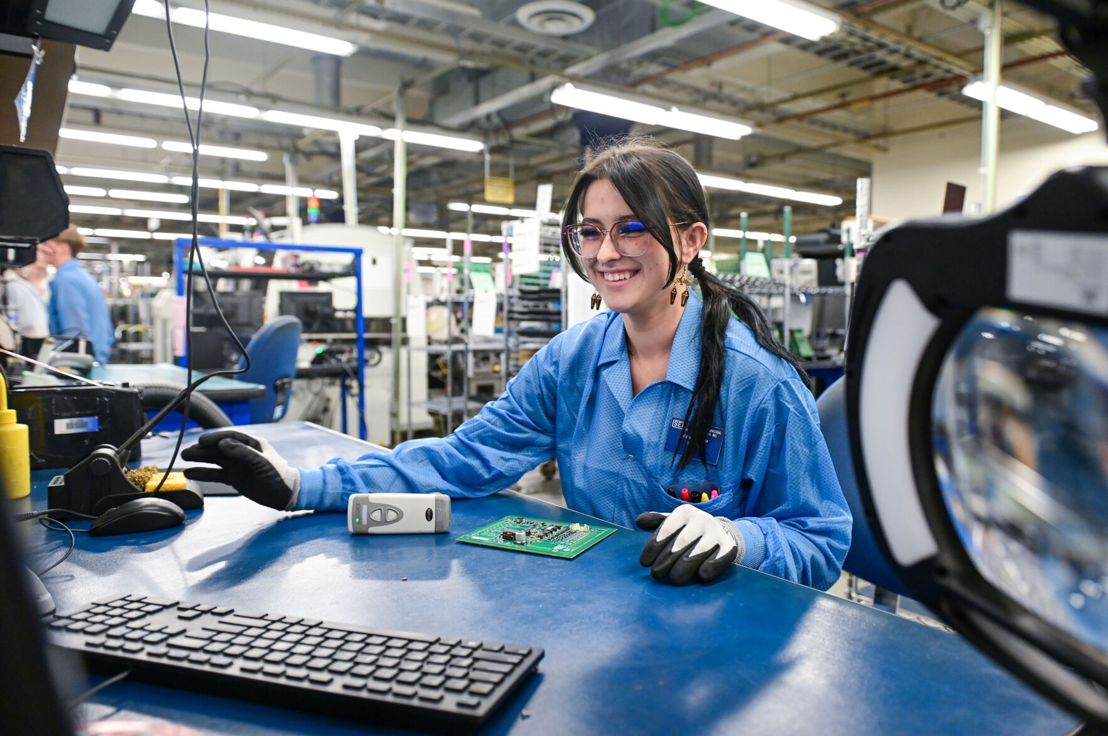 Anina Swanson, a Pullman High School senior and member of the Summer Assembler Program, looks up what preparations are needed for a batch of circuit boards at Schweitzer Engineering Laboratories on Thursday in Pullman.