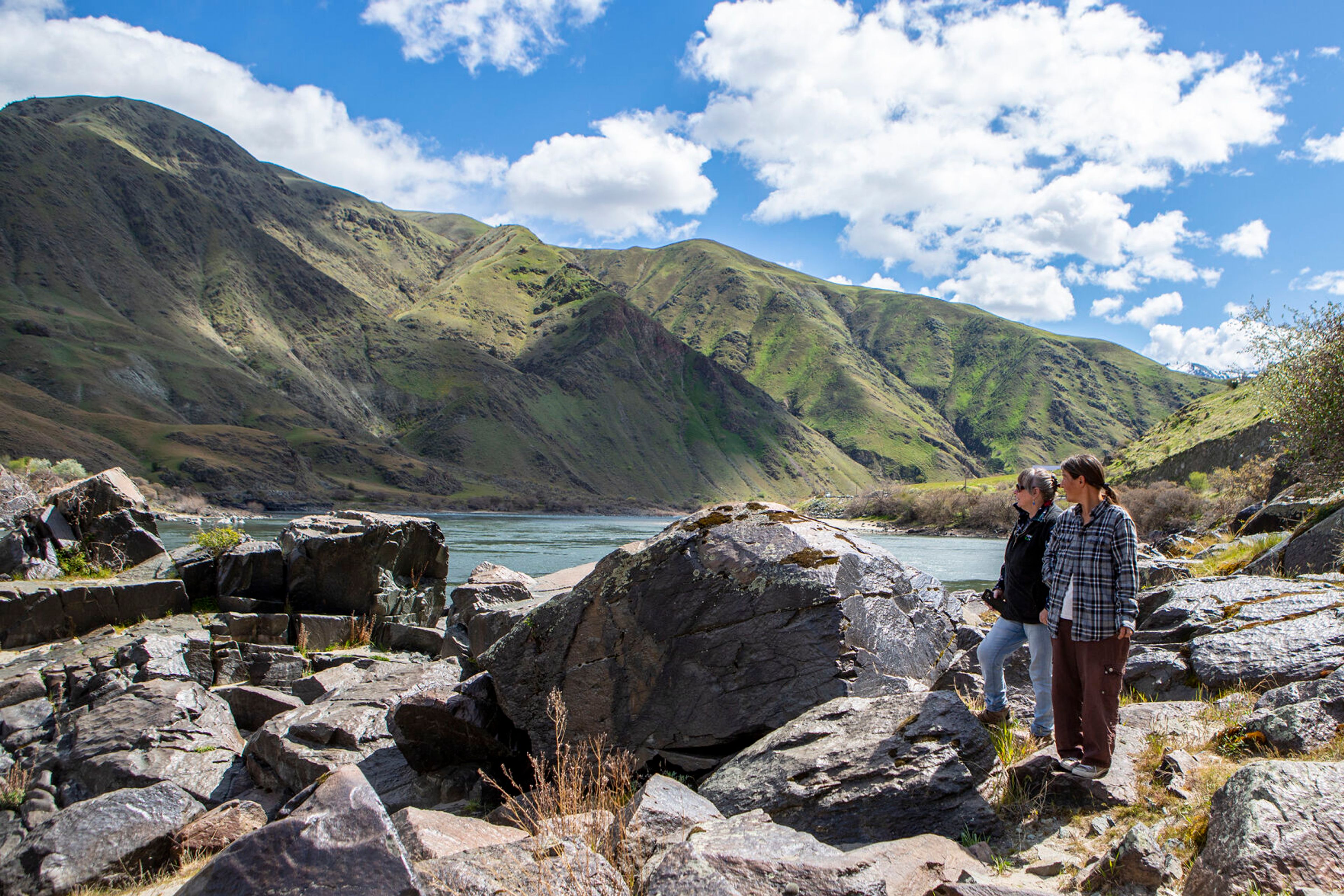 Cindy Reisinger, left, of Pomeroy, and her friend Anna Medici, visiting from Maine, explore the rocks at the Buffalo Eddy along the Snake River, 18 miles south of Asotin.