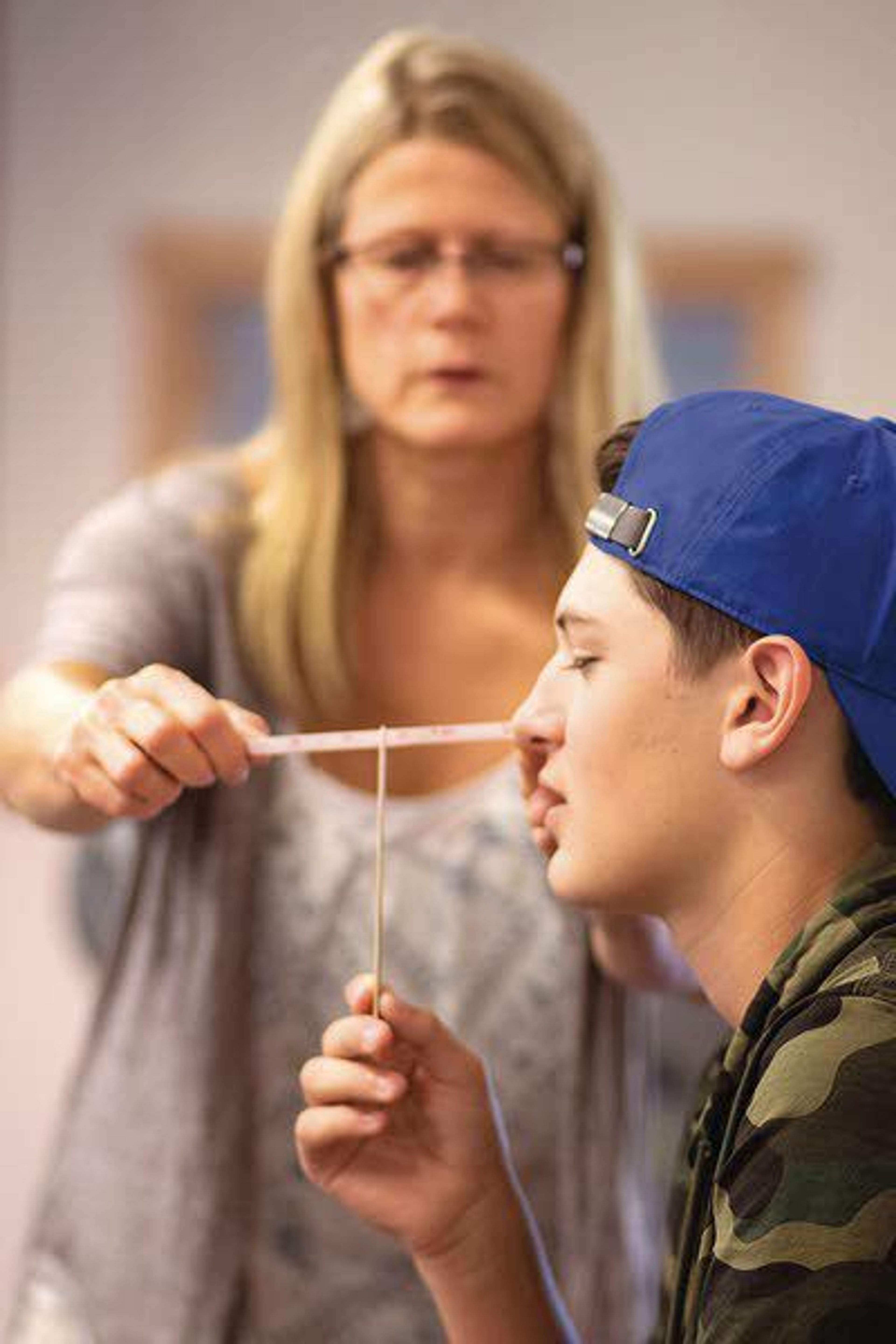 Physical therapist Marie Eriksson takes a measurement while evaluating Michael Kiblen to determine if he has a concussion Thursday at Moscow Mountain Sport and Physical Therapy in Moscow.