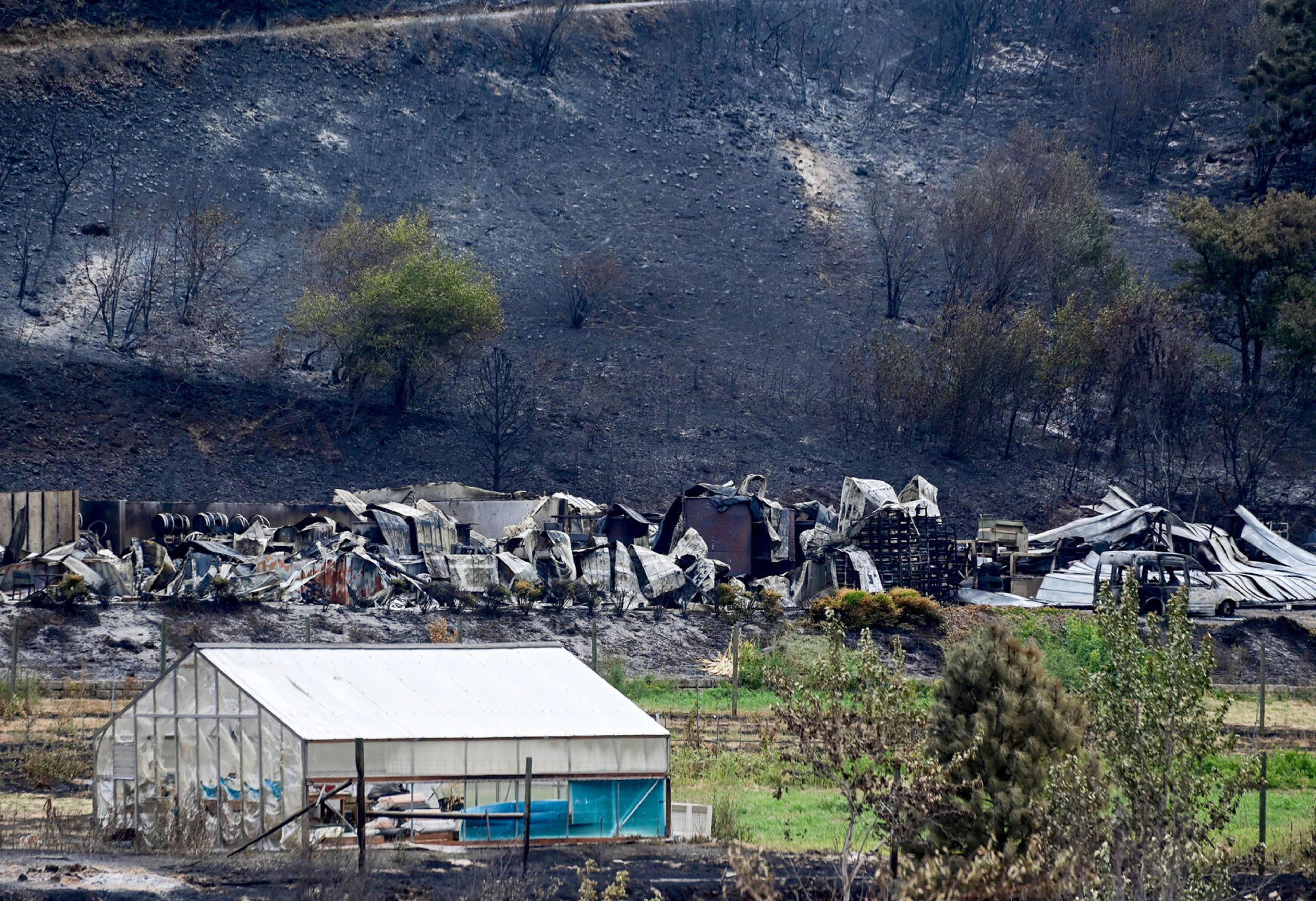 The remains of buildings used for the Colter’s Creek Winery operations, which burned down in the Gwen Fire, are visible from Idaho Highway 3 on Monday.