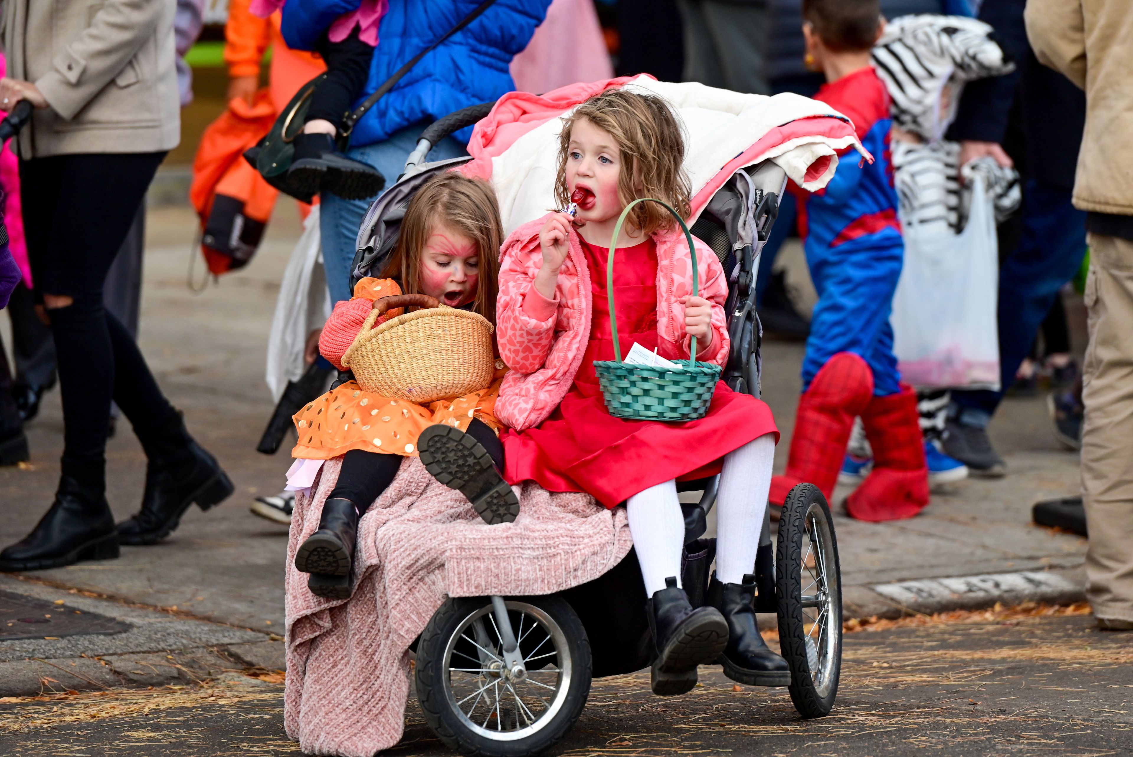 Picotee Harby, left, 3, yawns as Celeste Harby, 6, takes a candy break in a stroller during Moscow’s Downtown Trick-or-Treat on Tuesday.