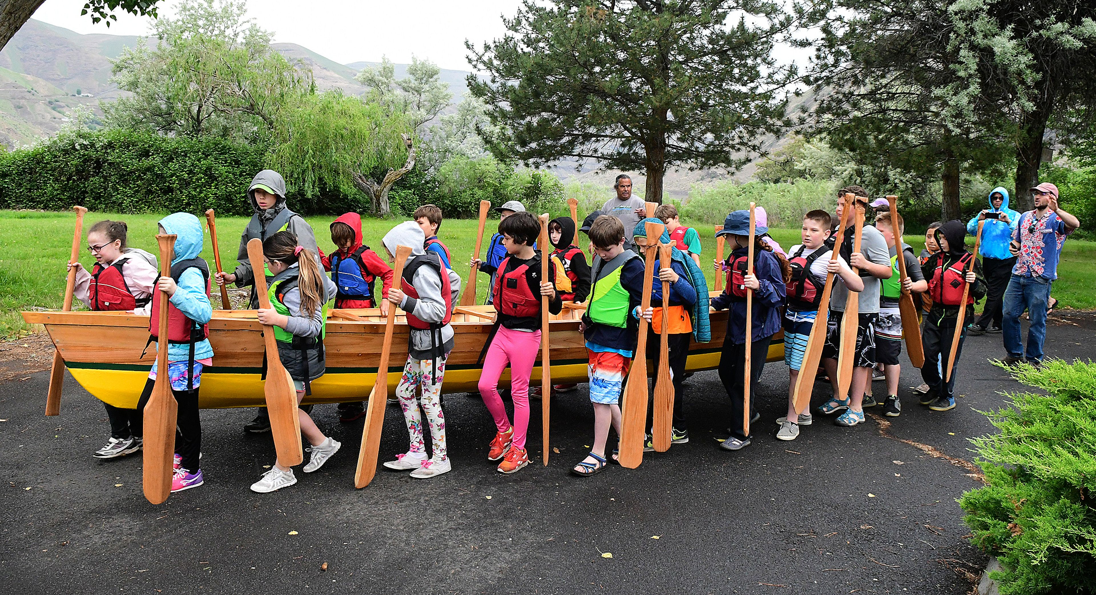 With guidance from Xander Demetrious and Adam Wicks-Arshack, Renee Hill’s fourth grade students built the 22 foot cedar plank canoe at Palouse Prairie Charter School at Moscow in their spare time over two months, while studying canoes and American Indian culture. With the help of Nez Perce Tribal members, the canoe, named The Chinook, was blessed Friday and then carried by all the students (“It’s heavy!”), and launched in the Snake River. The handmade boat was paddled around Silcott Island in a light rain. The canoe will be donated to the Nimiipuu Protecting The Environment group of the Nez Perce Tribe for teaching and regional demonstrations.