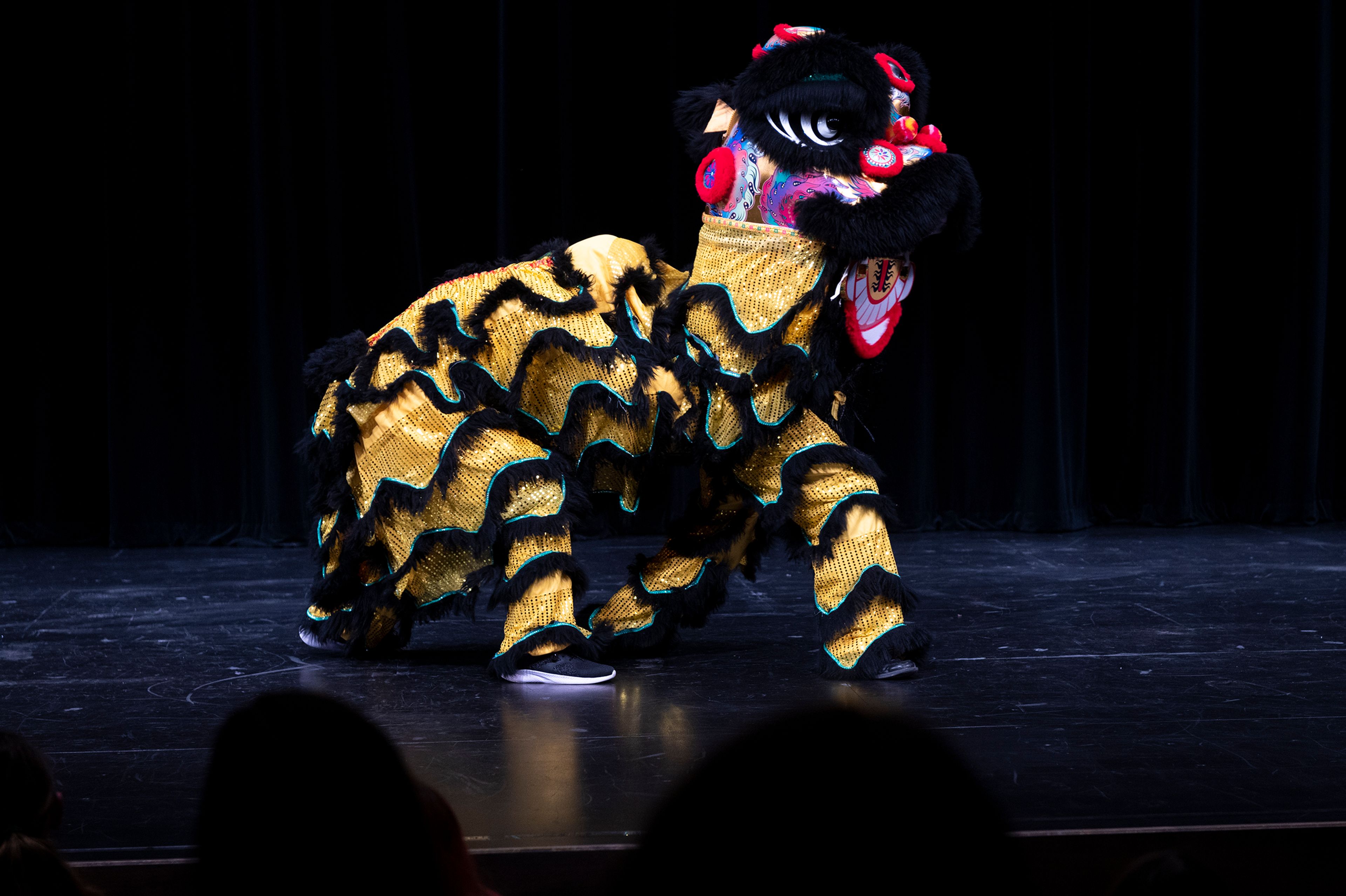 Ricky Ha and Jordan Feliciano perform a Vietnamese lion dance Friday at Pullman High School’s multicultural night.