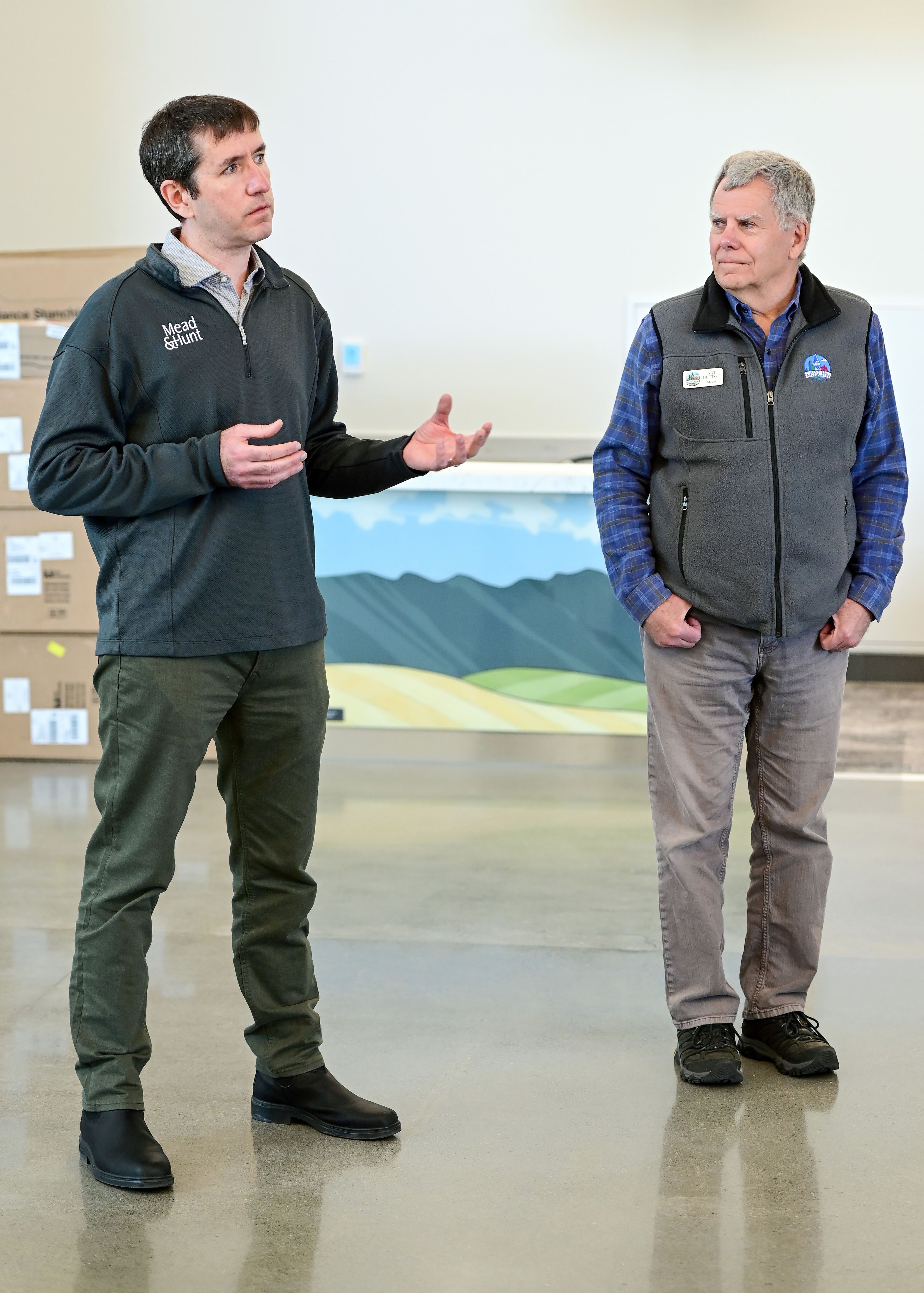 Tim Dacey, left, of Mead & Hunt, shares details about the architecture and planning for the new terminal at the Pullman-Moscow Regional Airport at Schweitzer Field alongside Moscow mayor Art Bettge during a media tour of the facilities in Pullman on Tuesday.