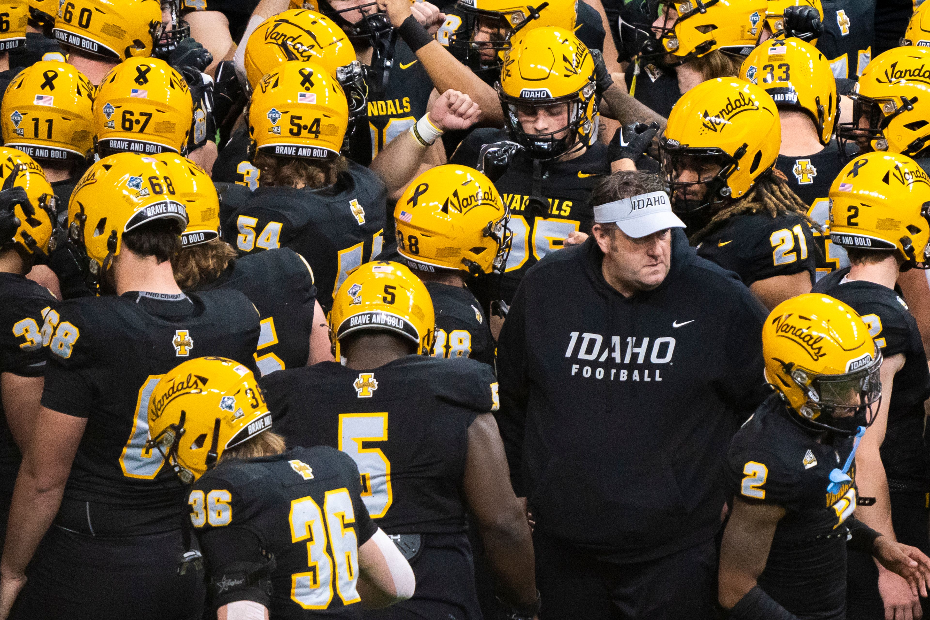 Idaho Vandals head coach Jason Eck, right, huddles up with his team before their game against Idaho State on Nov. 18 at the P1FCU Kibbie Dome in Moscow.