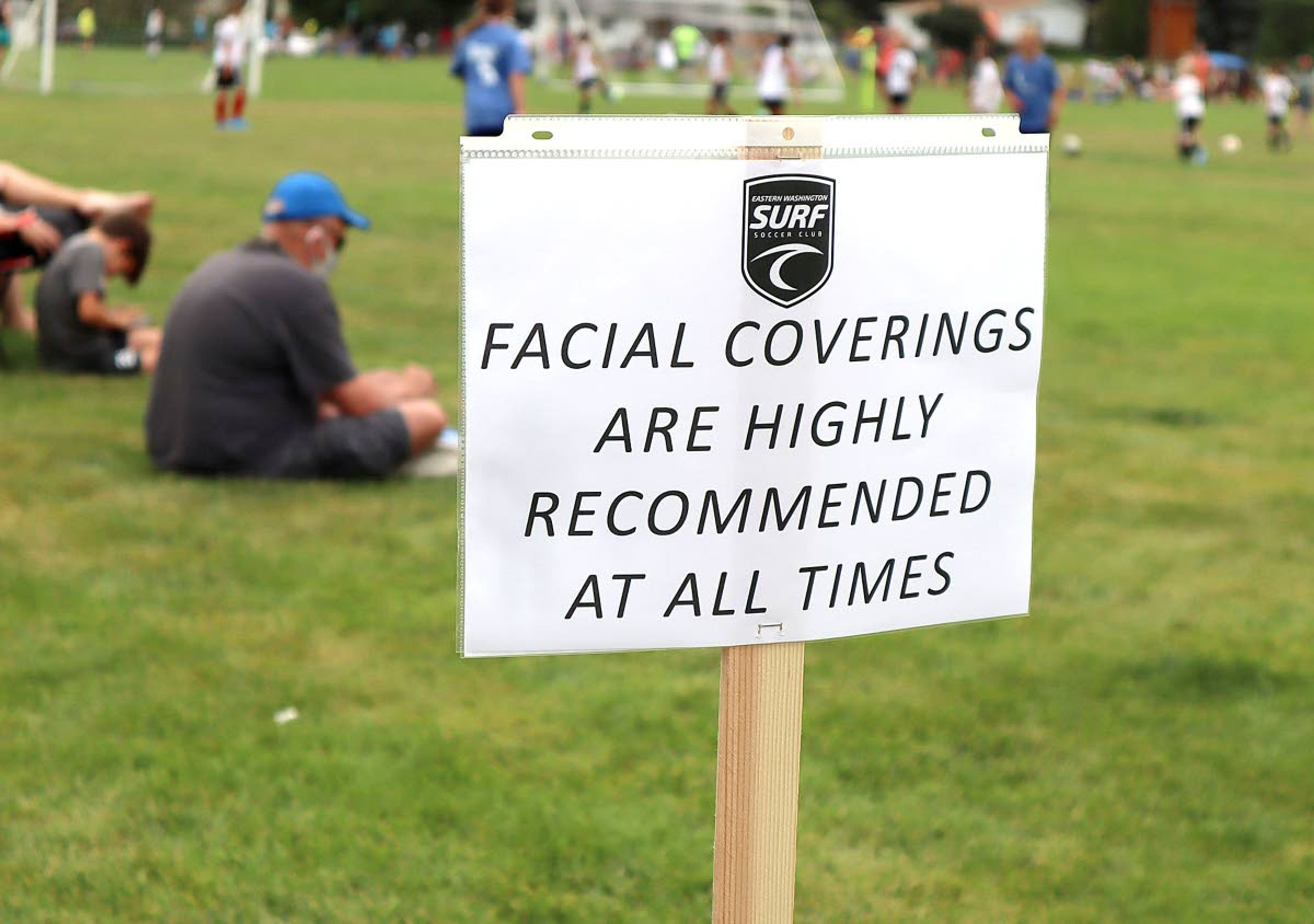 A sign encourages participants to wear facial coverings during the Eastern Washington Surf Soccer Club Harvest Cup soccer tournament at Oylear Field in Moscow. The tournament was shut down on Sunday for violating the Moscow Mayor's order to wear masks in public places when social distancing isn't possible.