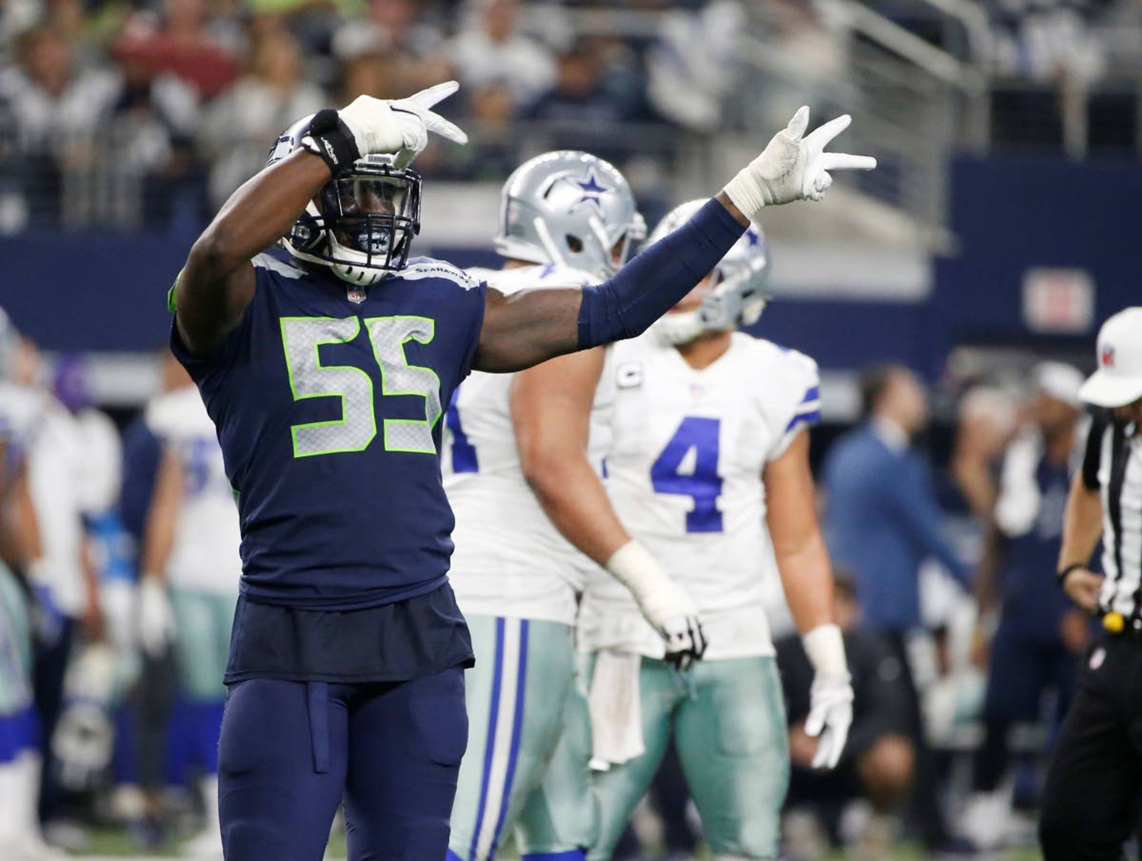 Seahawks defensive end Frank Clark (55) motions toward a penalty against Dallas on Dec. 24, 2017, during an NFL football game in Arlington, Texas.