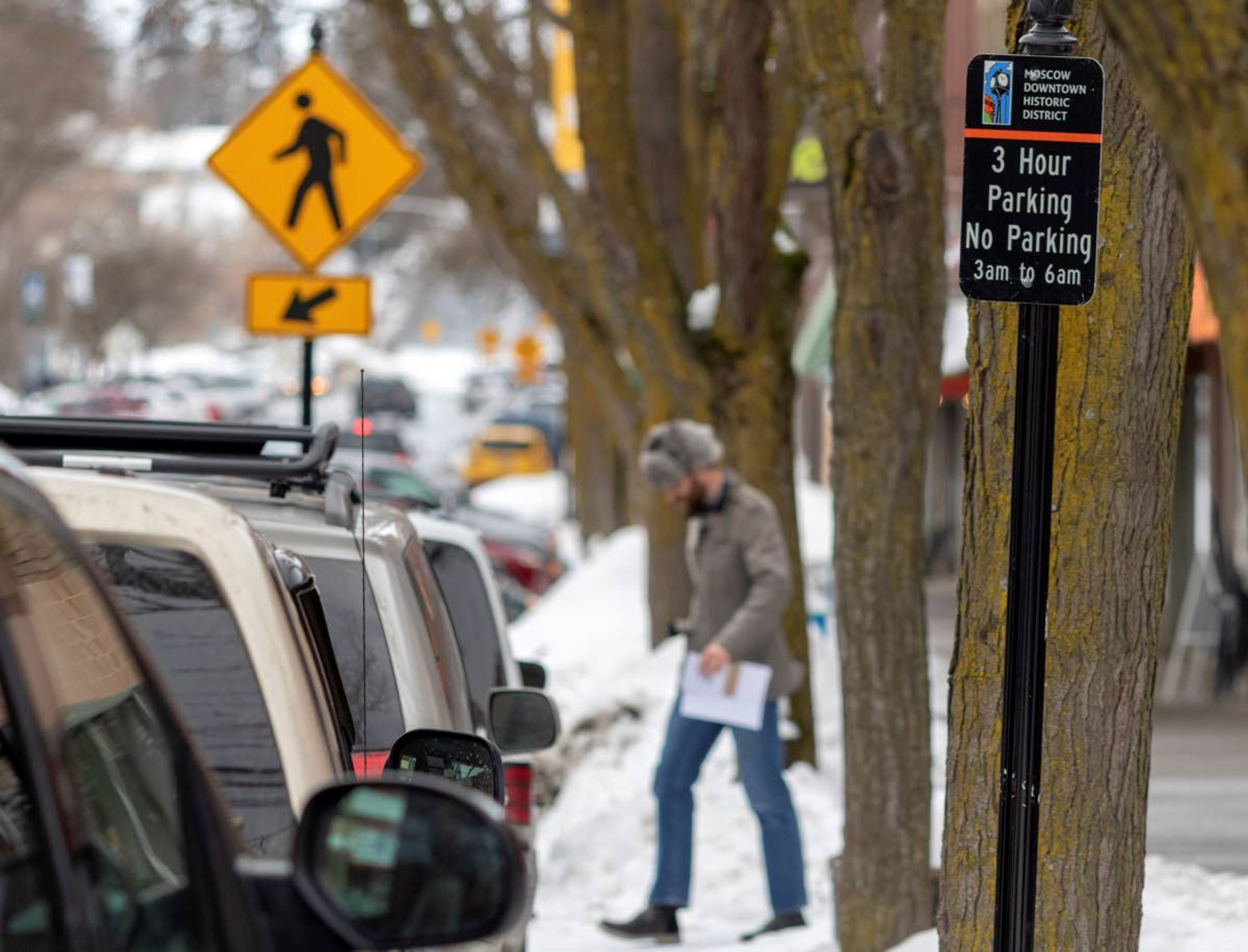 A man walks past parked cars on South Main Street on March 6 in Moscow.