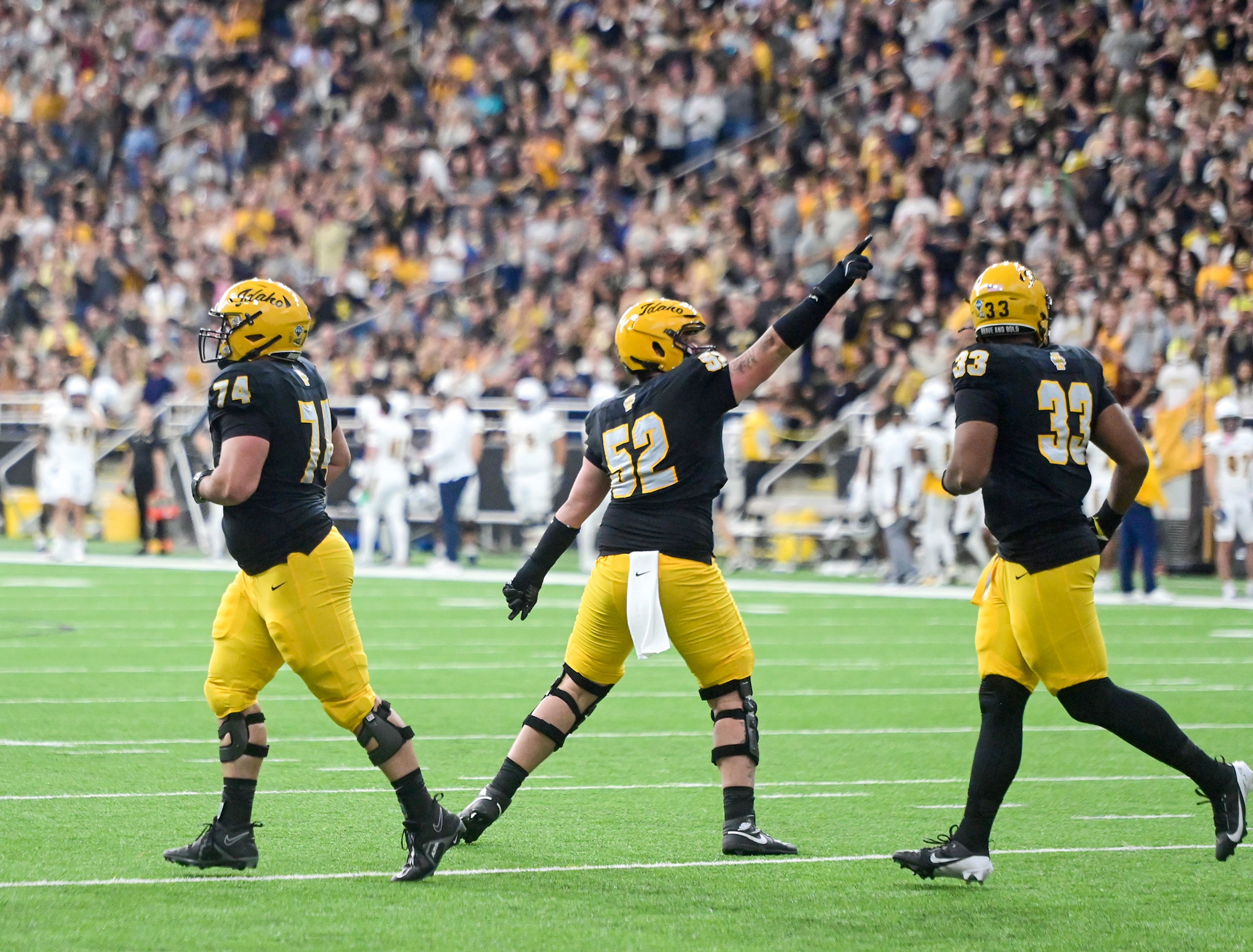 Idaho offensive lineman Kiegan Henson points to the scoreboard after a touchdown against Northern Arizona Saturday at the P1FCU Kibbie Dome in Moscow.,