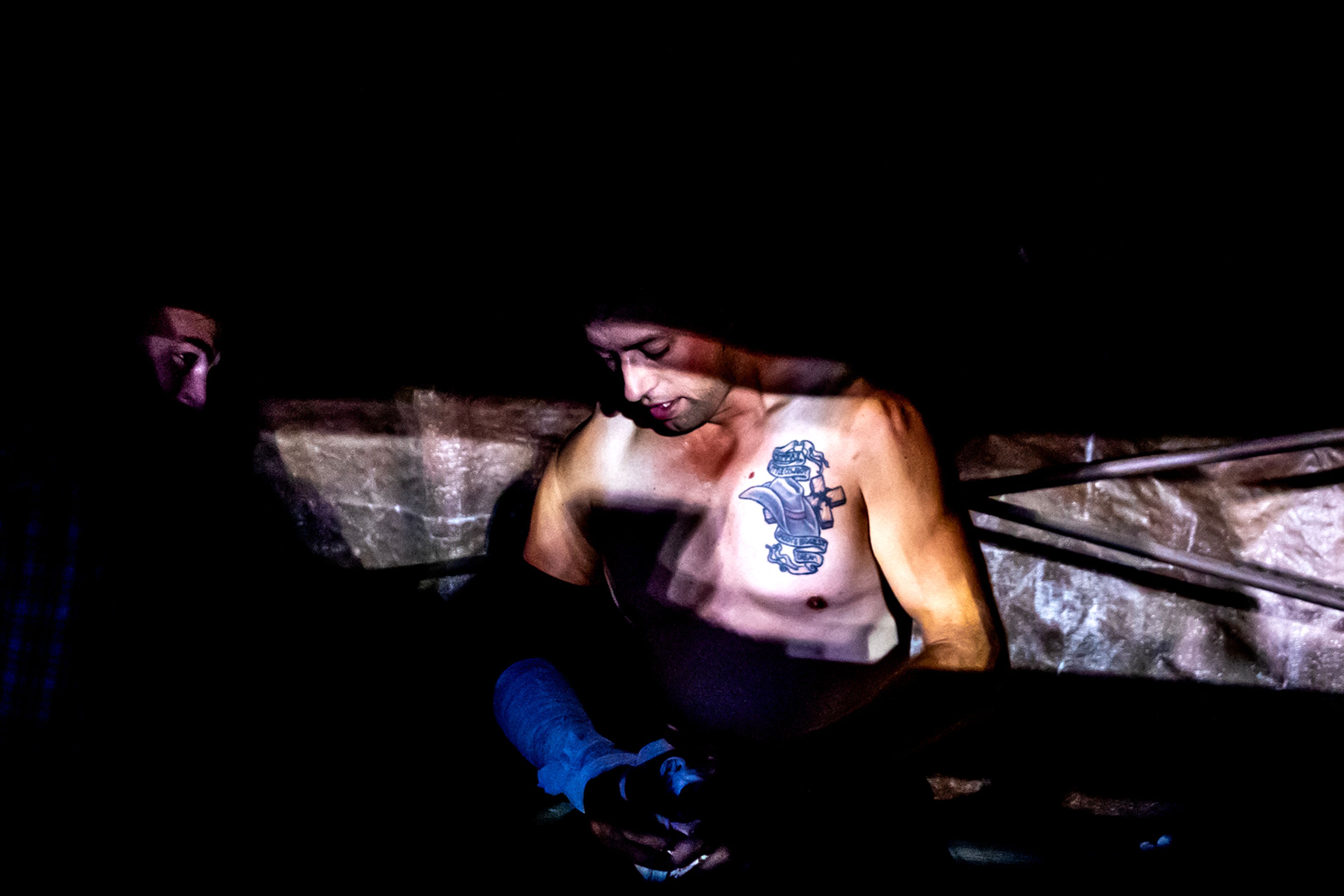 A cowboy sits under the stands on night 3 Friday at the Lewiston Roundup.