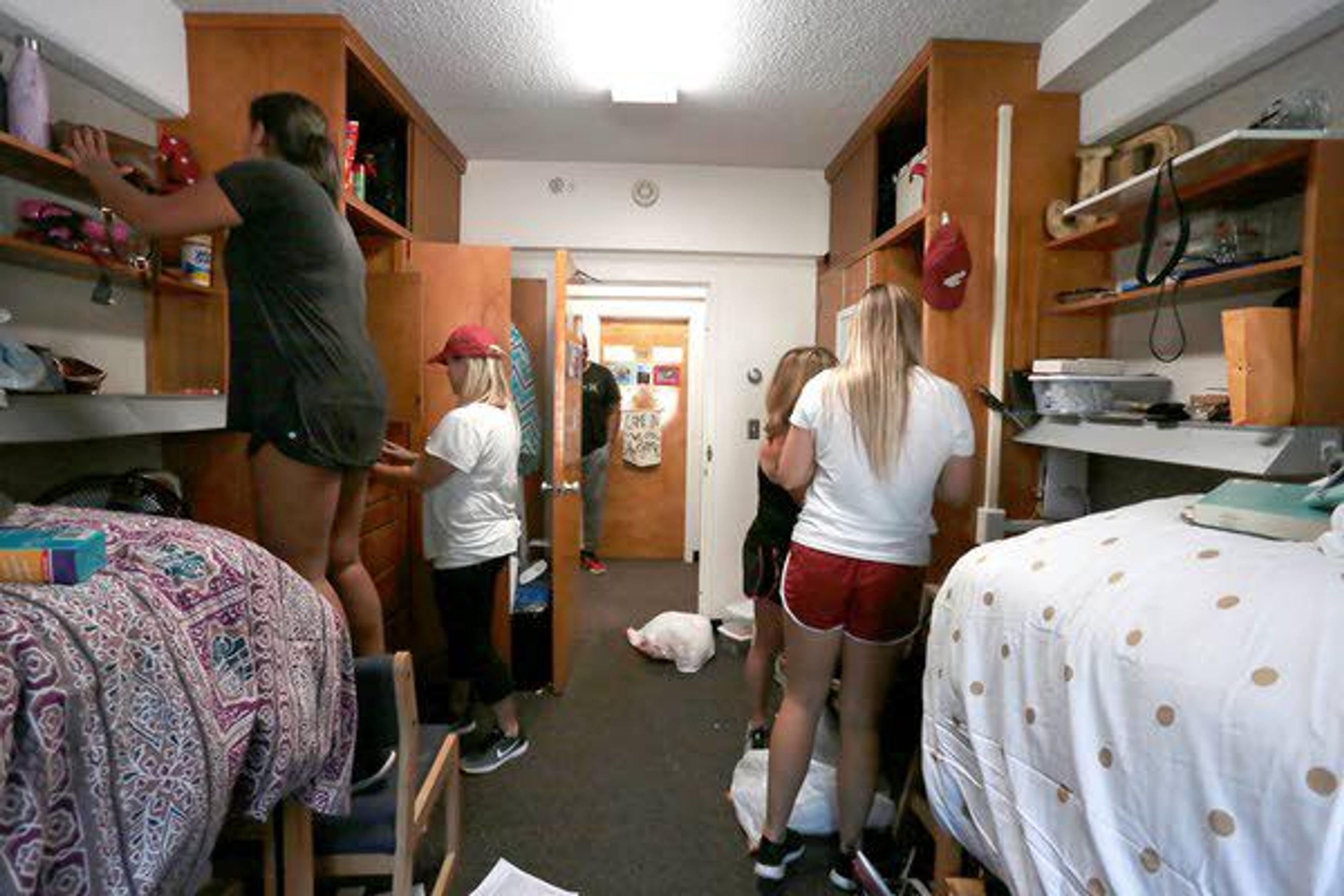 Alexa and Shelby McCoy and Jaimie and Maureen Bell move into their dorm room Saturday at Streit Hall at WSU.Tess Fox Daily News