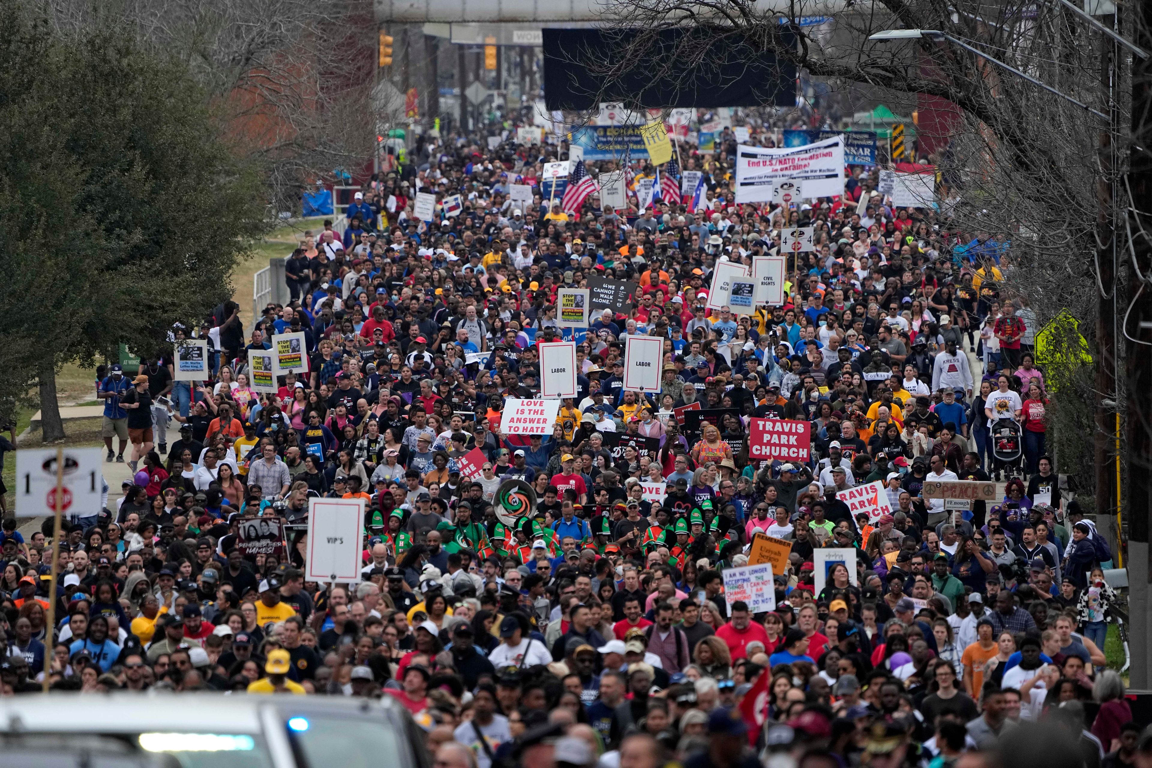 Thousands of walkers take part in a march honoring Martin Luther King Jr. in San Antonio, Monday, Jan. 16, 2023. (AP Photo/Eric Gay)