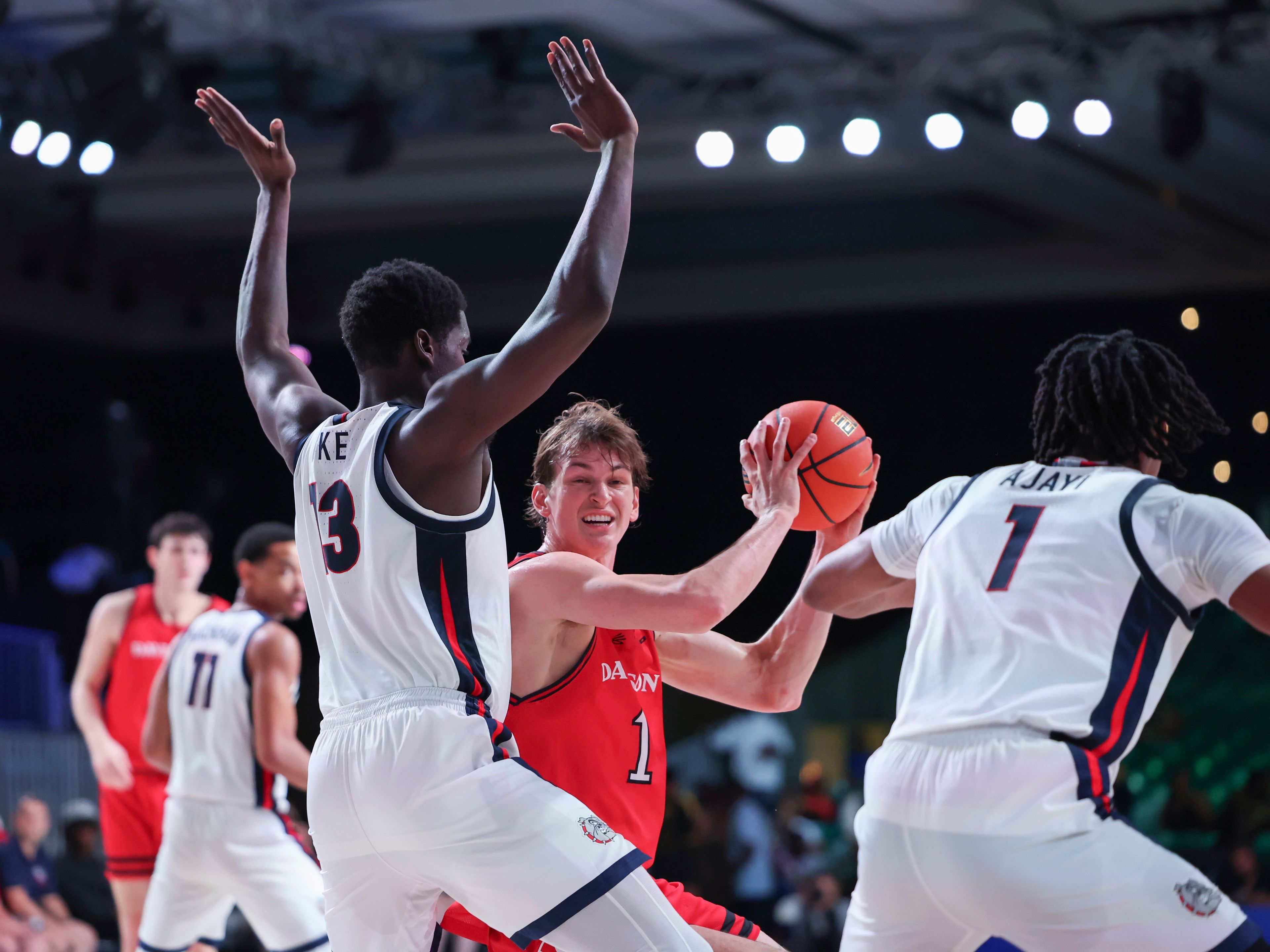 In this photo provided by Bahamas Visual Services, Davidson's Reed Bailey (1) controls the ball against Gonzaga's Graham Ike, front left, and Michael Ajayi during an NCAA college basketball game Friday, Nov. 29, 2024, in Paradise Island, Bahamas. (Tim Aylen/Bahamas Visual Services via AP)