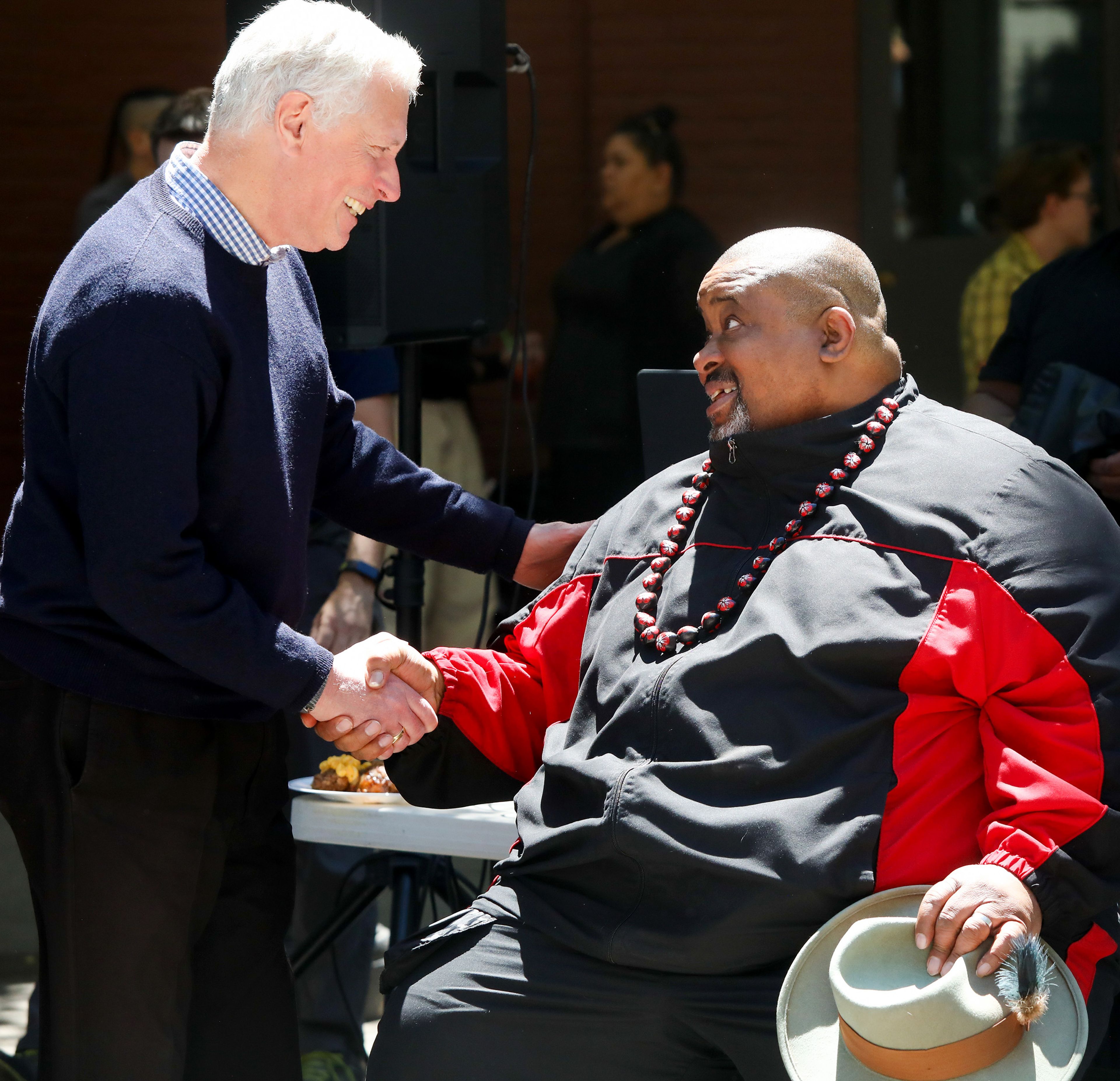 Bill Engels, left, of Pullman, shakes hands with James Montgomery Bledsoe after Bledsoe spoke at the Juneteenth celebration at Friendship Square on Wednesday in Moscow. Engels shared with Bledsoe that he believes he is a descendant of Sam Houston.