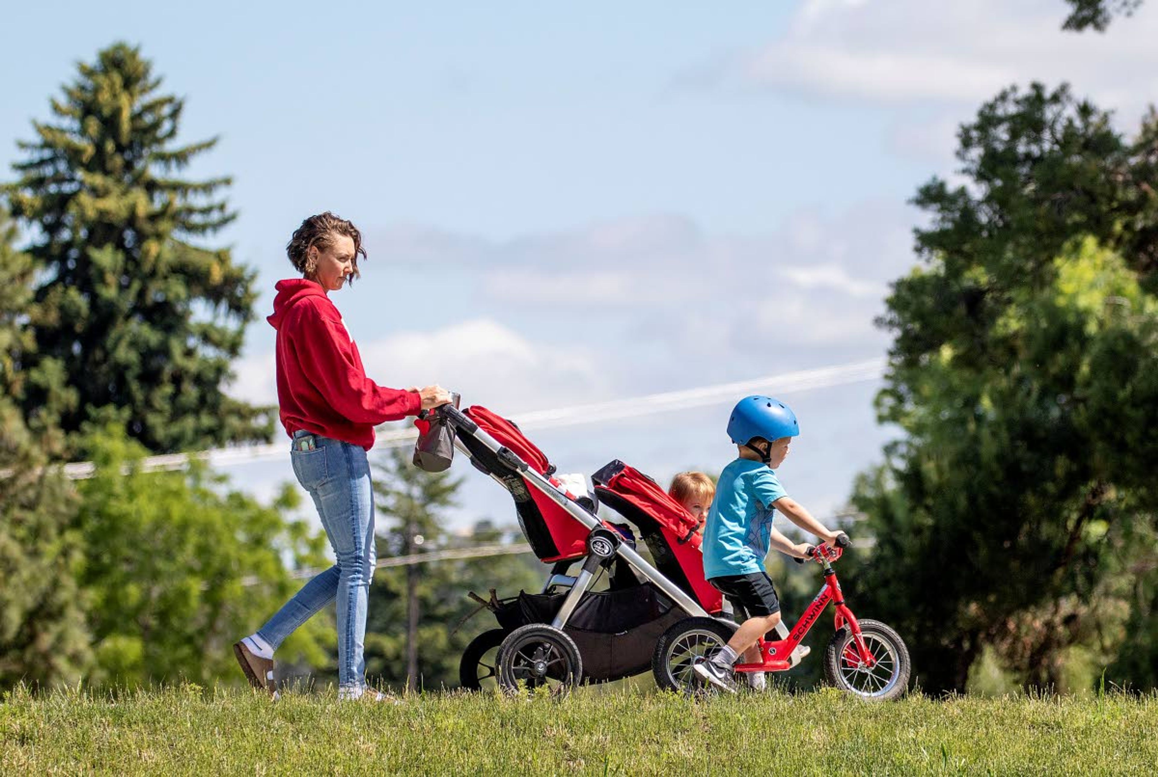 A family walks on a path on Thursday at Sunnyside Park in Pullman. Researches at Washington State University found that living in a pedestrian-friendly neighborhood with a mixed-age population could help contribute to a higher likelihood of living to age 100.