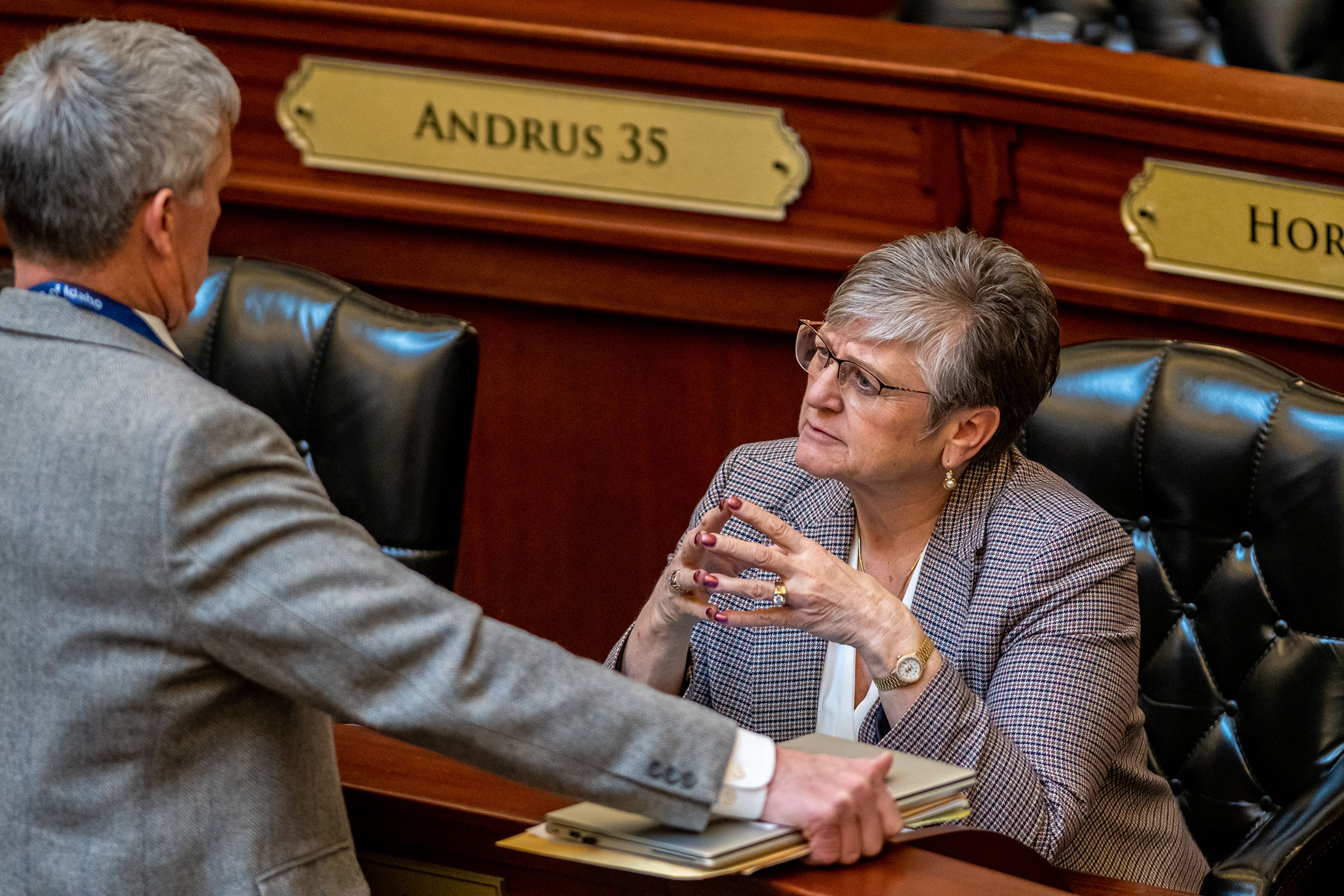 Representative Lori McCann, left, speaks with a colleague Tuesday following a legislative session regarding a ban on transgender care for minors at the Capitol Building in Boise.