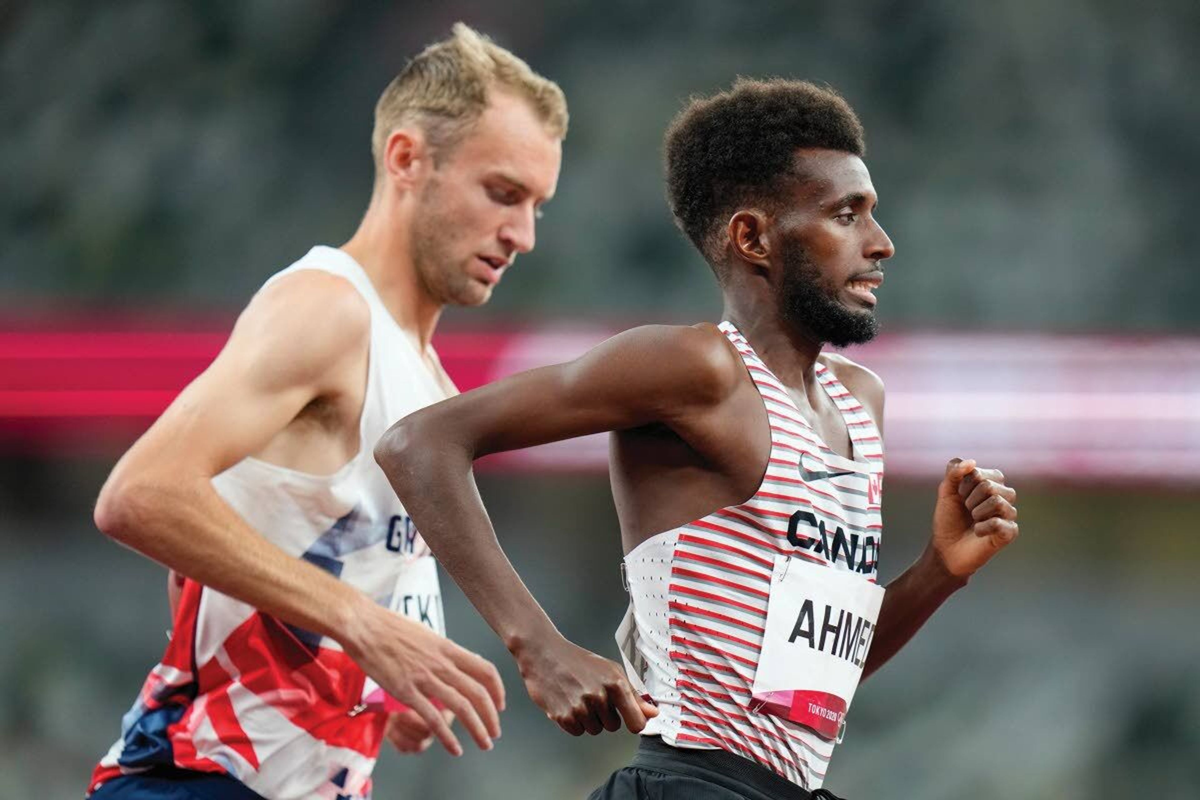 Former Lewis-Clark State standout runner and current cross country assistant coach Sam Atkin, left, runs with Canada’s Mohammed Ahmed during the men’s 10,000-meter run at the 2020 Summer Olympics on Friday in Tokyo. Atkin, representing Great Britain, dropped out about midway through the race.