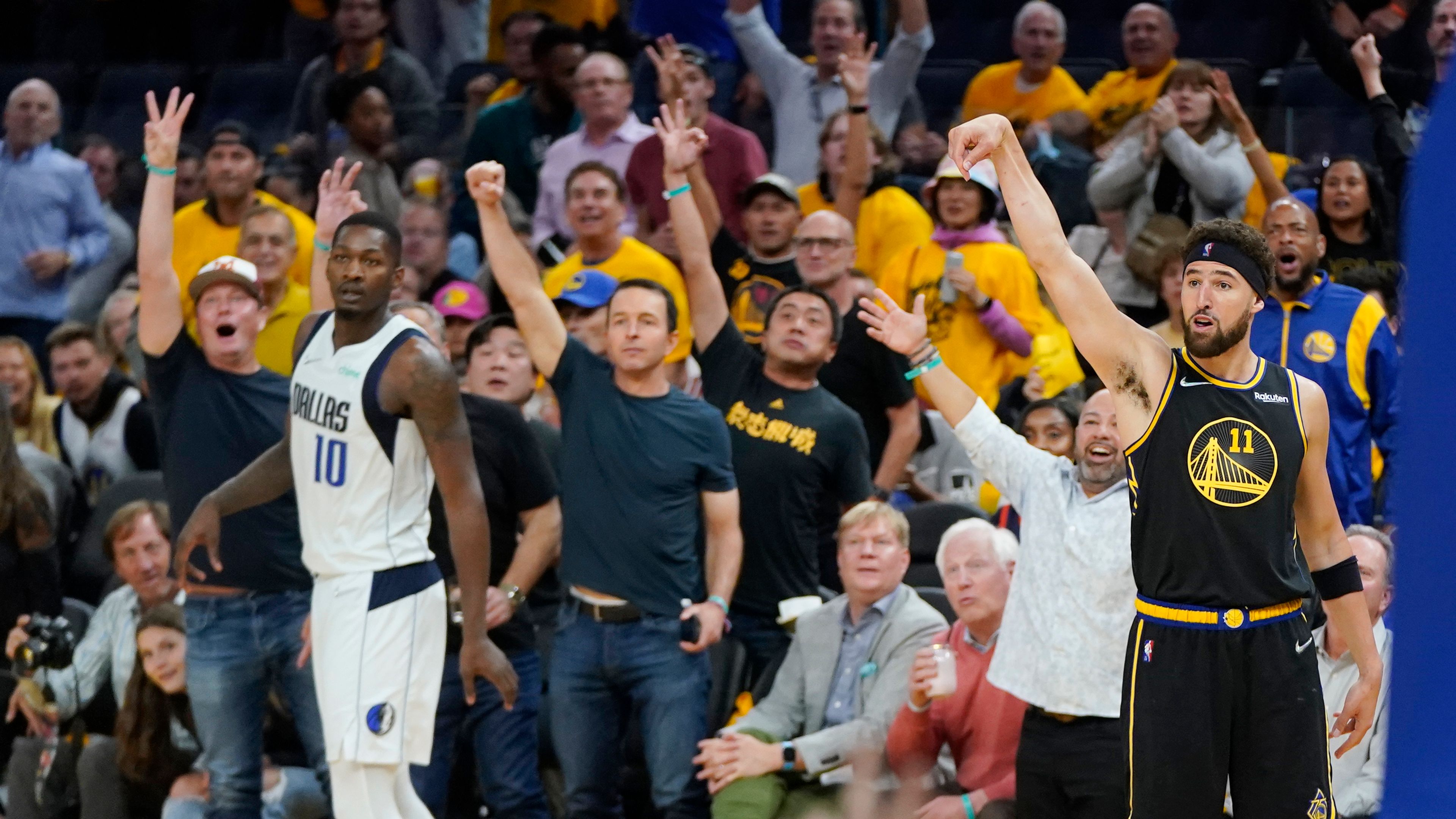 Golden State Warriors guard Klay Thompson (11) watches a 3-point basket next to Dallas Mavericks forward Dorian Finney-Smith (10) during the second half in Game 5 of the NBA basketball playoffs Western Conference finals in San Francisco, Thursday, May 26, 2022. (AP Photo/Jeff Chiu)