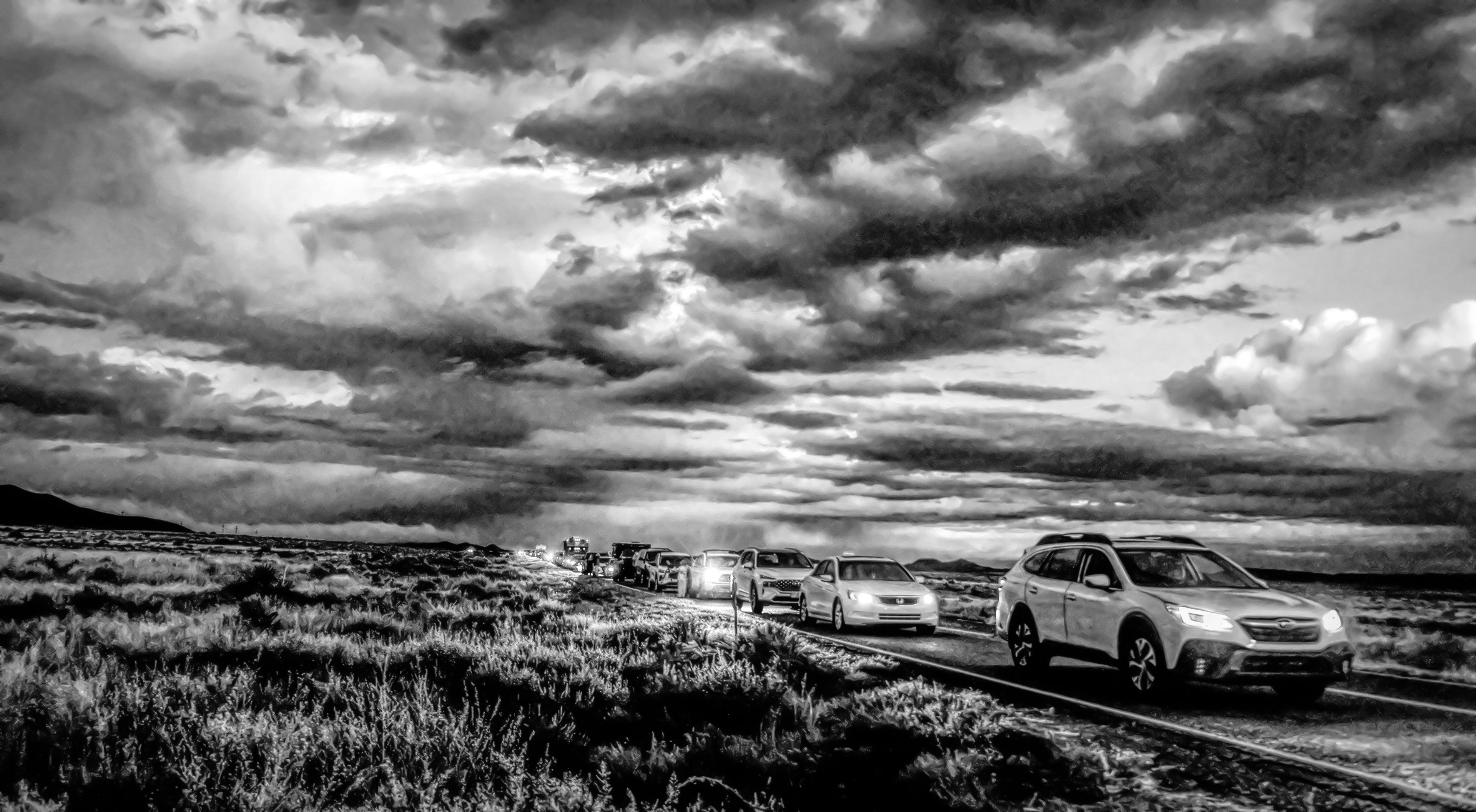 Cars line up under a pre-dawn storm to visit the Trinity Site at the White Sands Missile Range in New Mexico.,