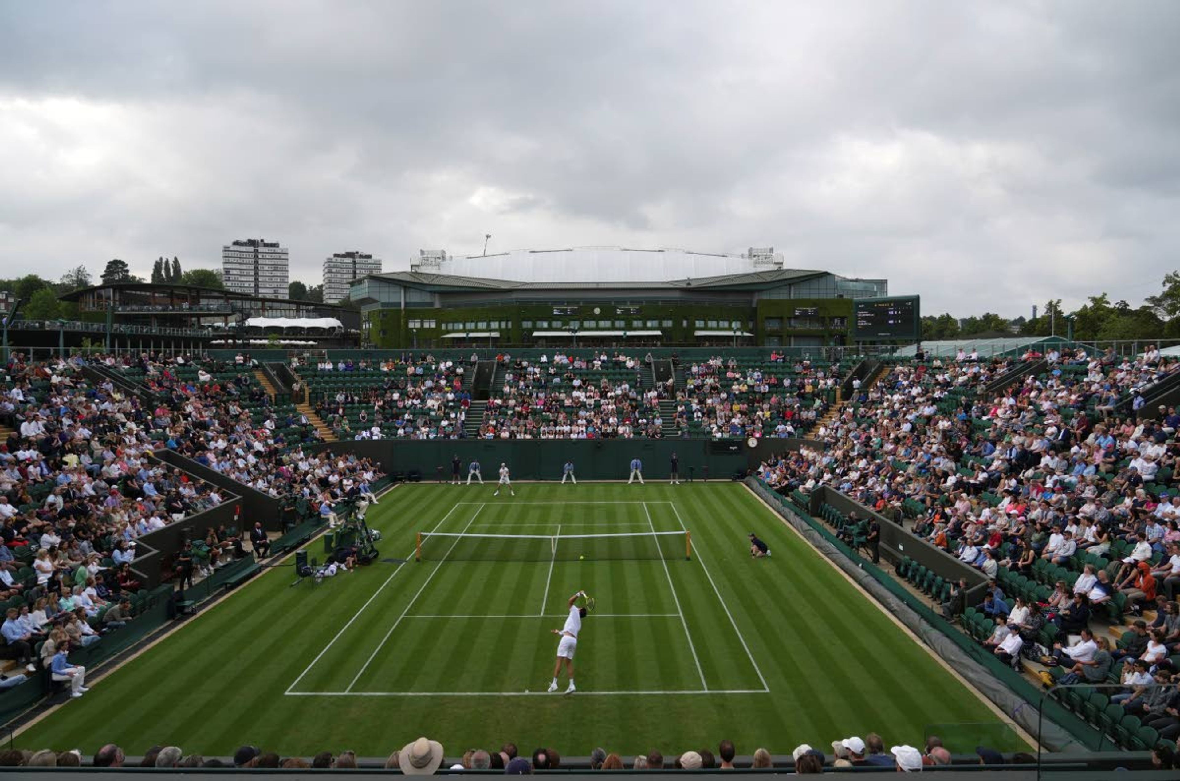 Argentina's Federico Delbonis serves to Russia's Andrey Rublev during the men's singles match on day one of the Wimbledon Tennis Championships in London, Monday June 28, 2021. (AP Photo/Alberto Pezzali)