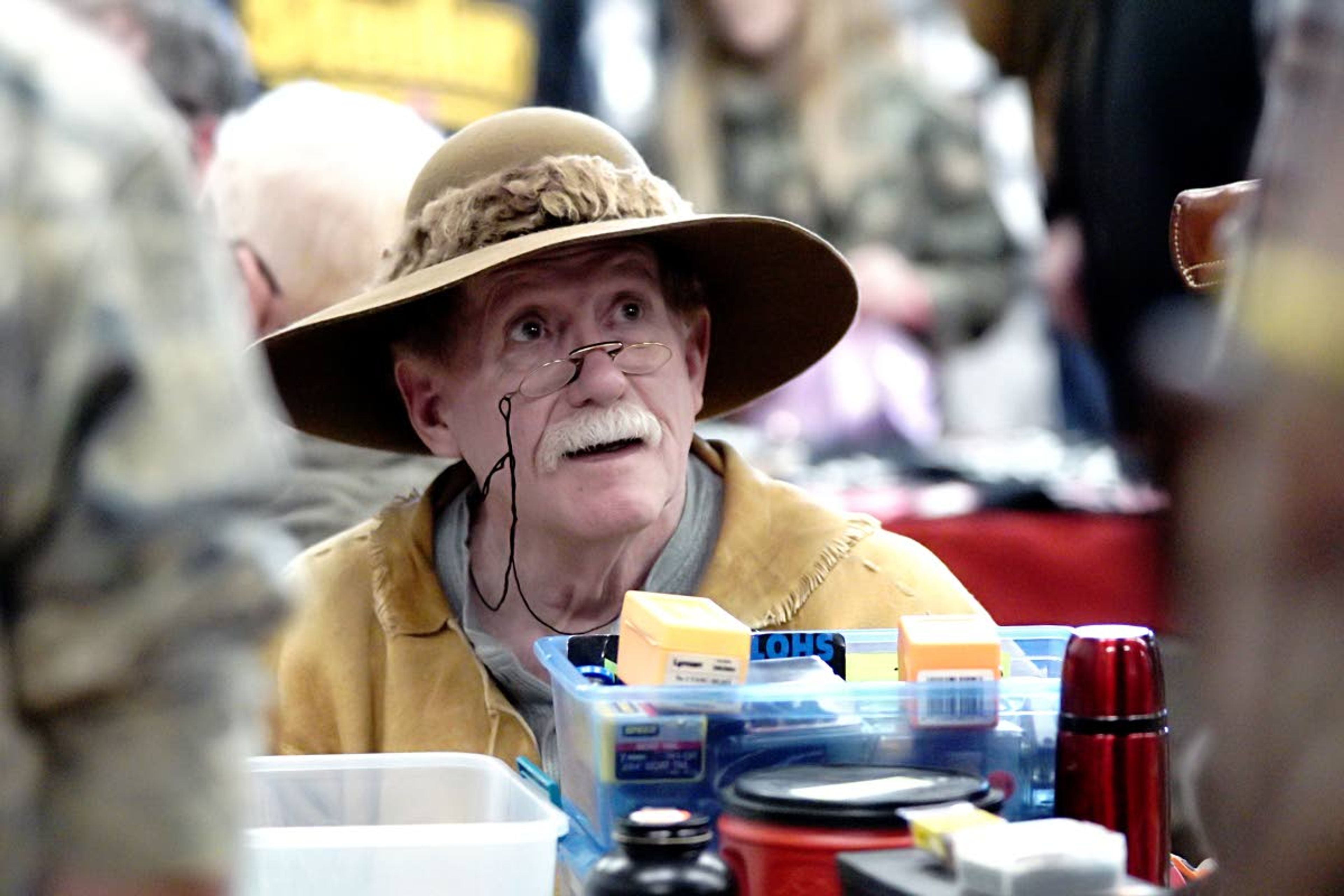 Kai Eiselein/Daily NewsSteve Gregory, who lives in Spokane Valley and grew up in Oaksdale, talks to customers at his table at the Potlatch Gun Show Sunday.