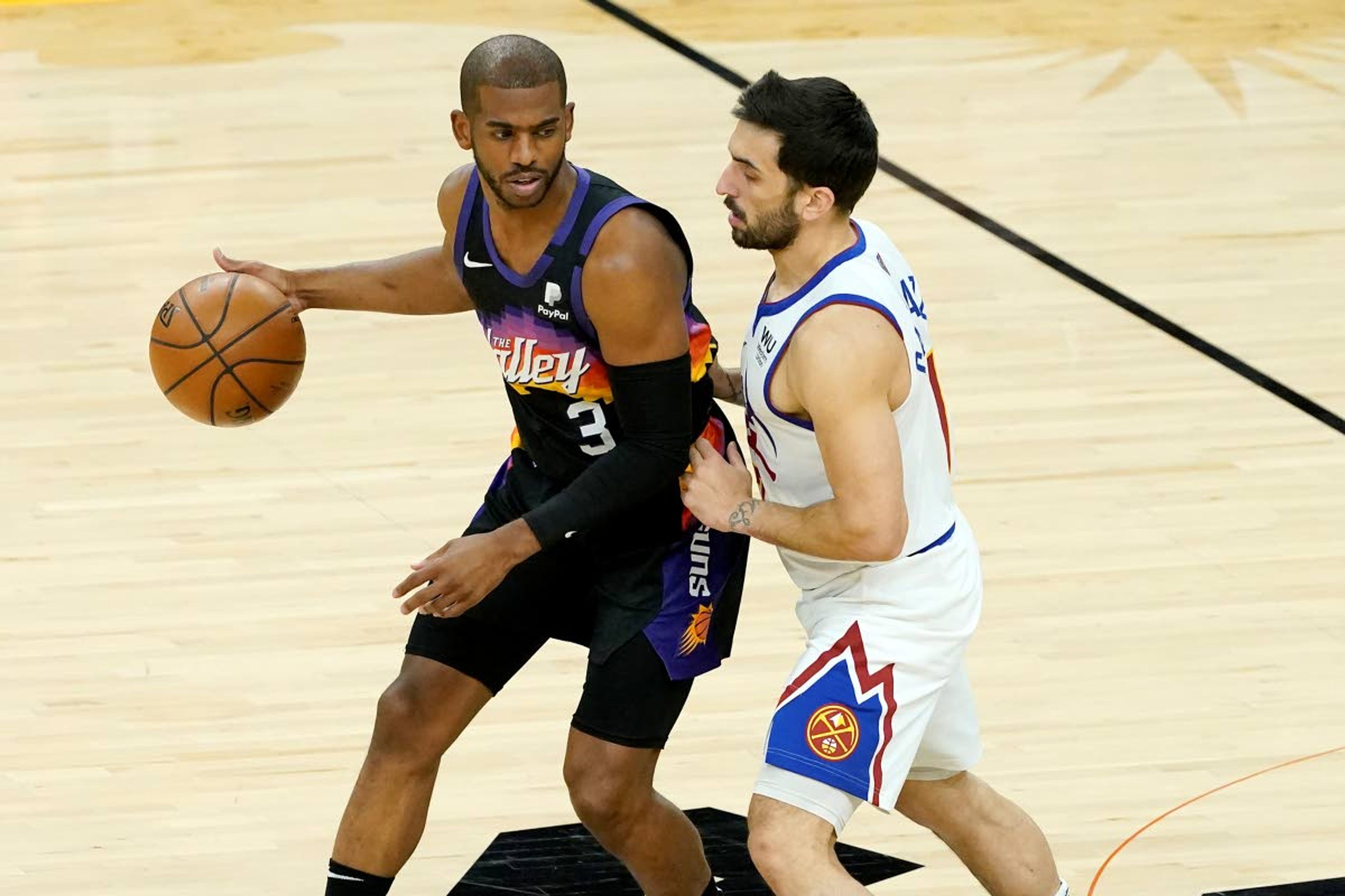 Associated PressSuns guard Chris Paul is defended by the Nuggets’ Facundo Campazzo during the first half of Wednesday’s Game 2 of their playoff series in Phoenix. The Suns won 123-98 and now lead the series 2-0.