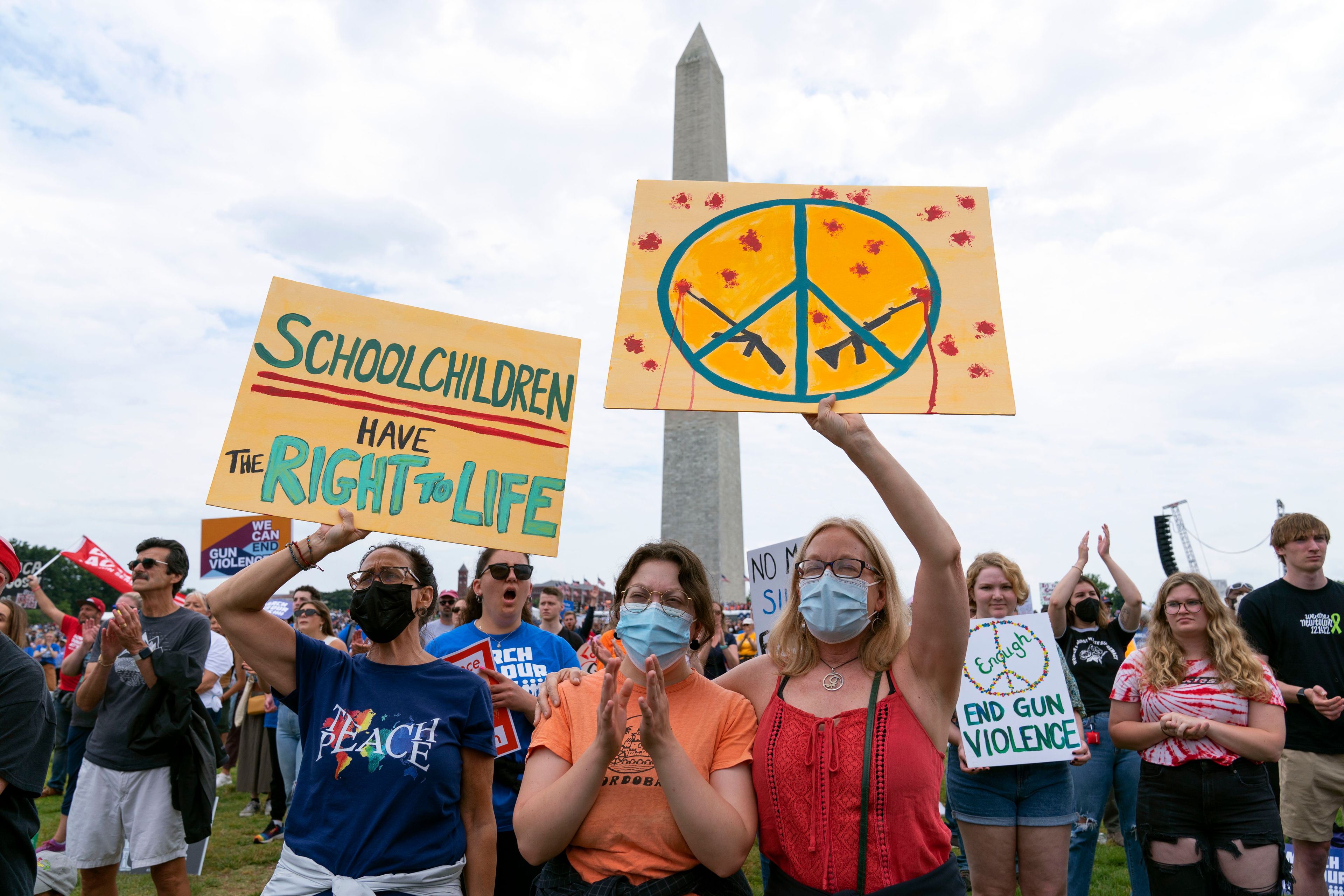 People hold signs in the second March for Our Lives rally in support of gun control in front of the Washington Monument, Saturday, June 11, 2022, in Washington. The rally is a successor to the 2018 march organized by student protestors after the mass shooting at a high school in Parkland, Fla. (AP Photo/Jose Luis Magana)