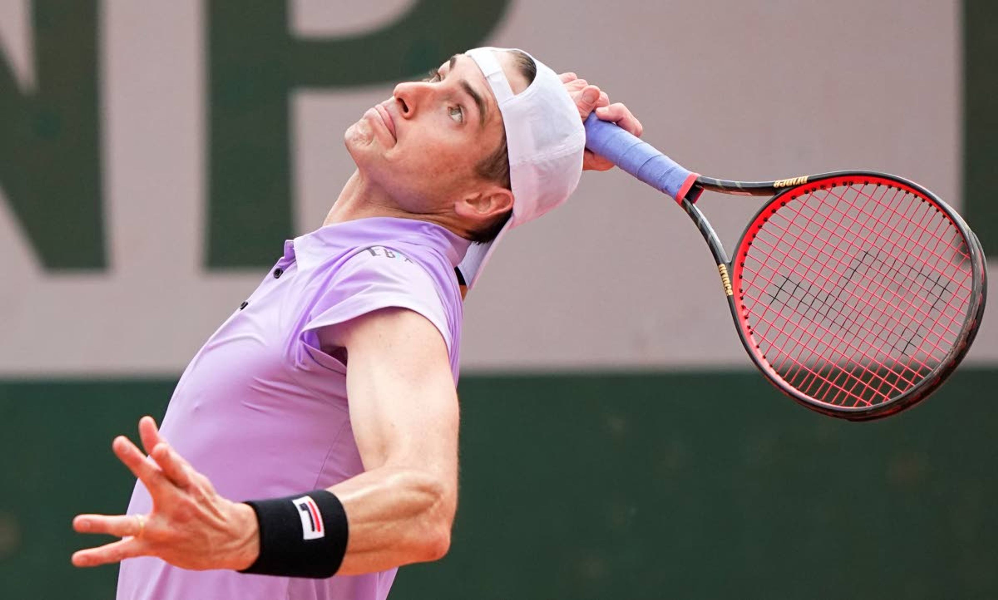 United States' John Isner serves to Serbia's Filip Krajinovic during their second round match on day four of the French Open tennis tournament at Roland Garros in Paris, France, Wednesday, June 2, 2021. (AP Photo/Michel Euler)