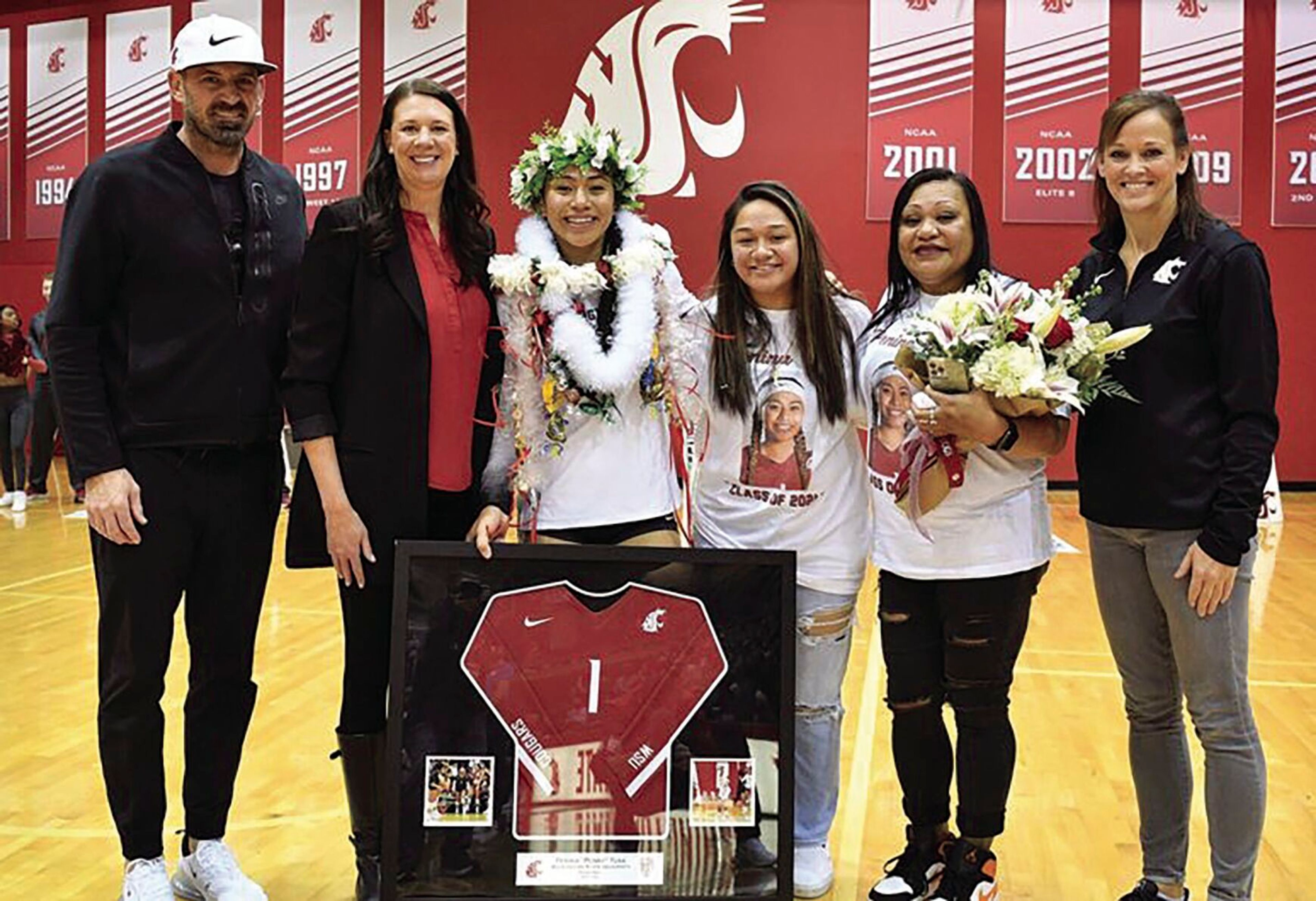 From left, Washington State associate volleyball coach Burdette Greeny, head coach Jen Greeny and senior outside hitter Penny Tusa stand with Tusa's family members and assistant Shannon Hunt, far right, during ceremonies for Senior Day on Sunday. The Cougar volleyball team beat Oregon State in three sets.