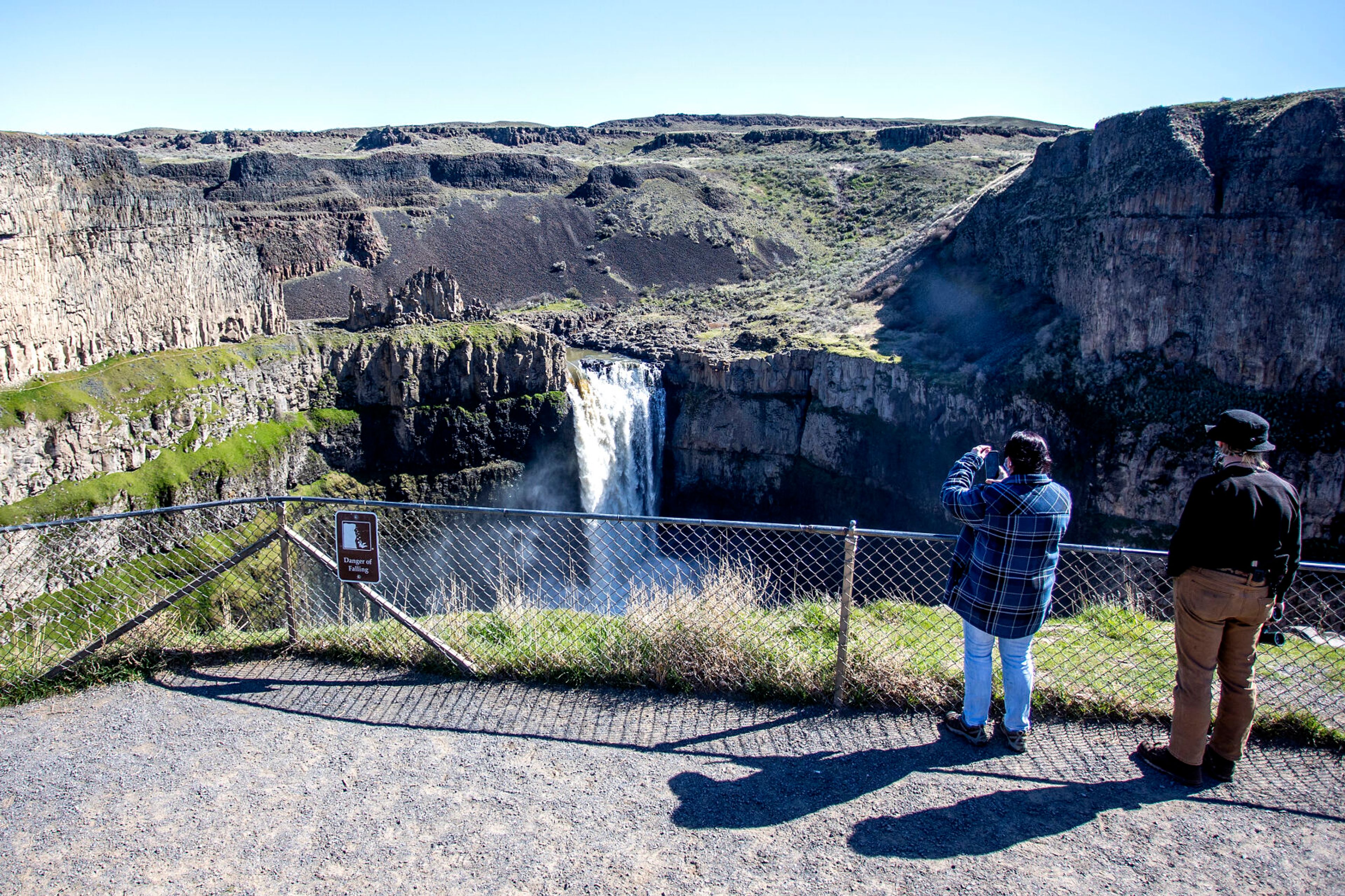 People take photos of Palouse Falls in the summer of 2021.